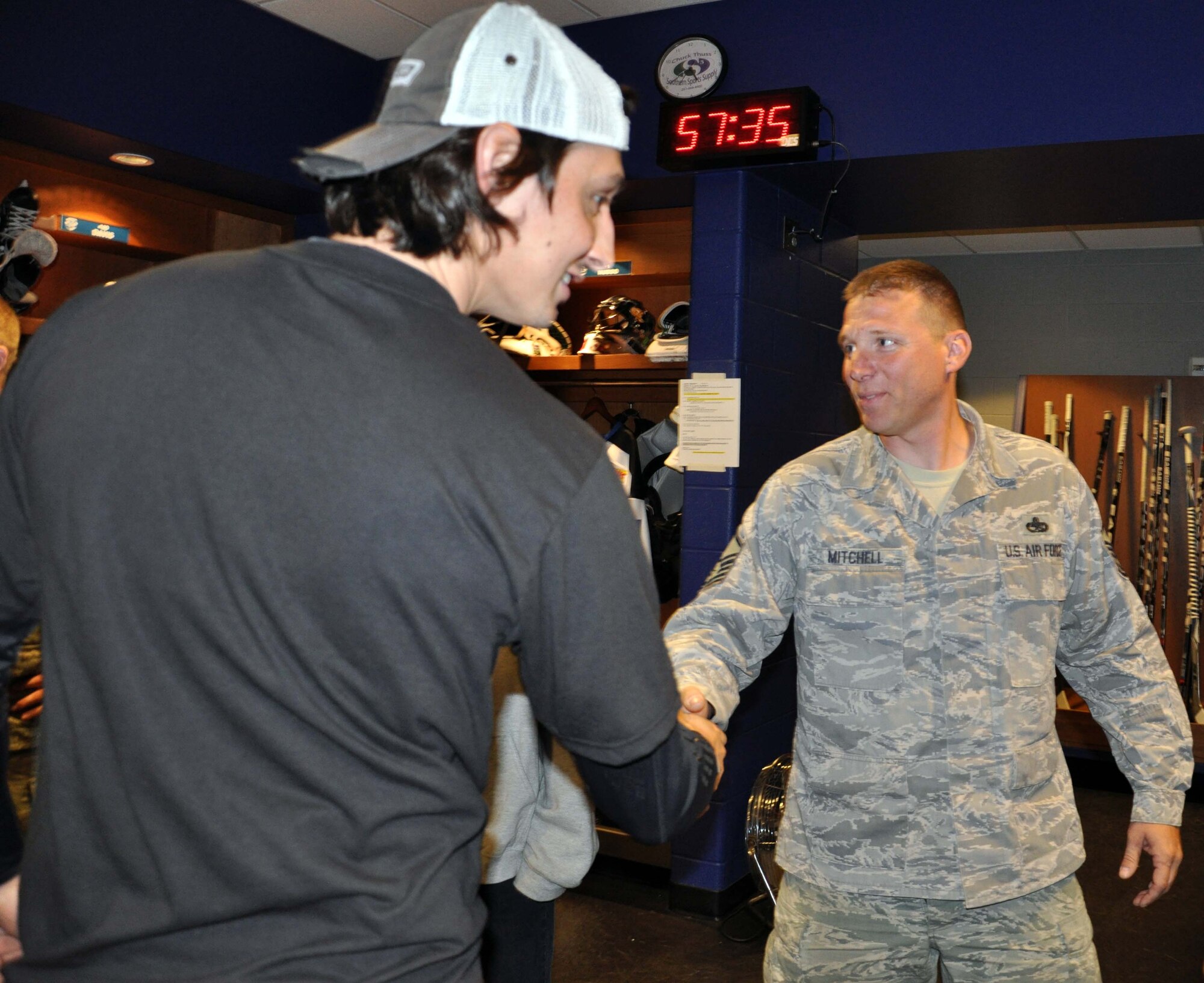 Master Sgt. Gregory Mitchell of the 931st Air Refueling Group meets with players from the Wichita Thunder hockey team during a locker room visit prior to a game game, Nov. 11, 2011.  The locker room visit was part of the Wichita Thunder Veterans Day game activities, during which several McConnell Airmen were honored for their service.  (U.S. Air Force photo by 1st Lt. Zach Anderson)