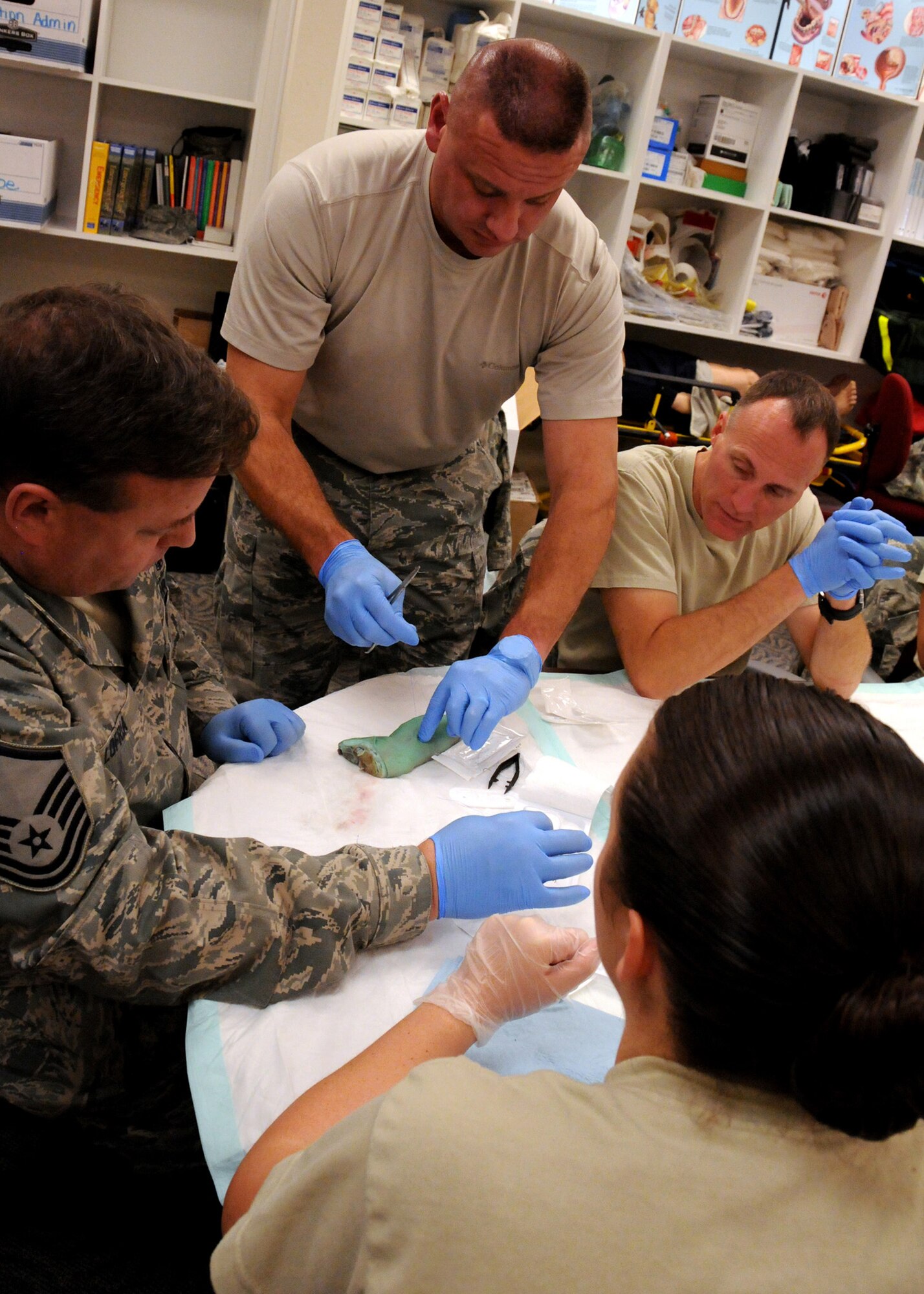 Air Force Reserve Maj. Darrell Surratt of the 919th Medical Squadron demonstrates a stitch for a simple suture on a lacerated pig’s foot at Duke Field, Fla., Nov. 6.  The 919th MDS conducted training on simple- interrupted sutures and mattress sutures using pigs’ feet during the November unit training assembly. (U.S. Air Force photo/Tech. Sgt. Cheryl L. Foster)