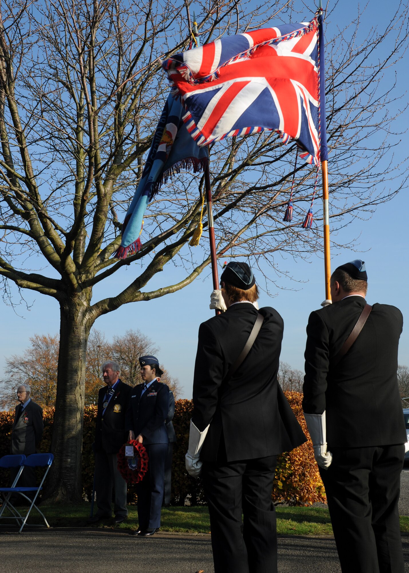 NEWMARKET, England – Royal Air Force cadets hold their unit flag and the British flag during a Remembrance Day ceremony at the Rowley Mile Racecourse in Newmarket Nov. 13, 2011. The area Rowley Mile is built upon was an RAF airfield, and home to the 99th Squadron from September 1939 to March 1941, and is now one of the most popular horse racing facilities in England. (U.S. Air Force photo/Tech. Sgt. Kevin Wallace)