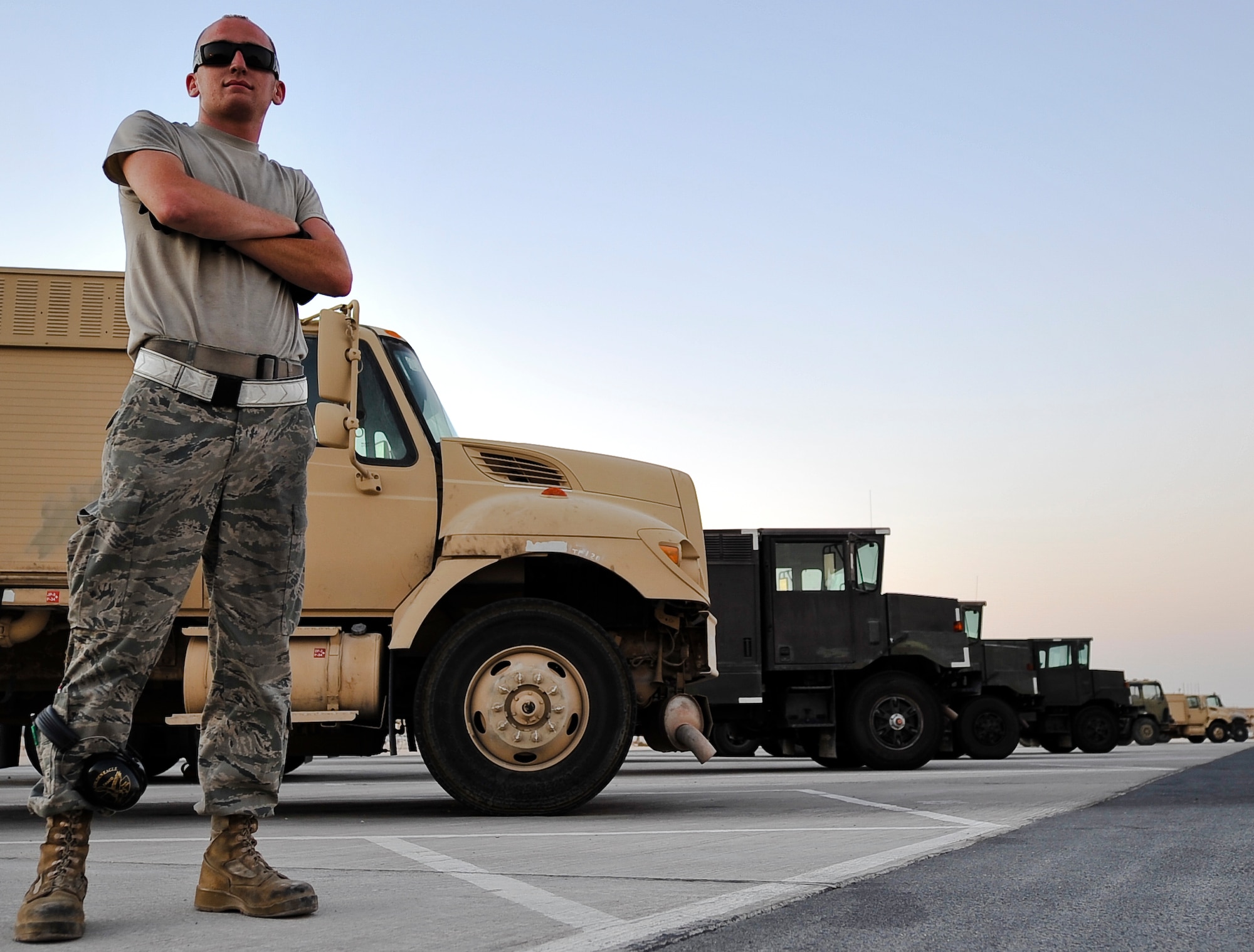 Airman 1st Class Kyle Lorms, 379th Expeditionary Logistics Readiness Squadron fuels distribution operator, poses in front of a row of R-11 fuel trucks Oct. 23, 2011, at an undisclosed location in Southwest Asia. Lorms, whose average response time from the call for fuel to being planeside was eight minutes, completed more than 235 fuel runs. Lorms, a native of Albuquerque, N.M., is deployed from Dyess Air Force Base, Texas. (U.S. Air Force photo/Senior Airman Paul Labbe)