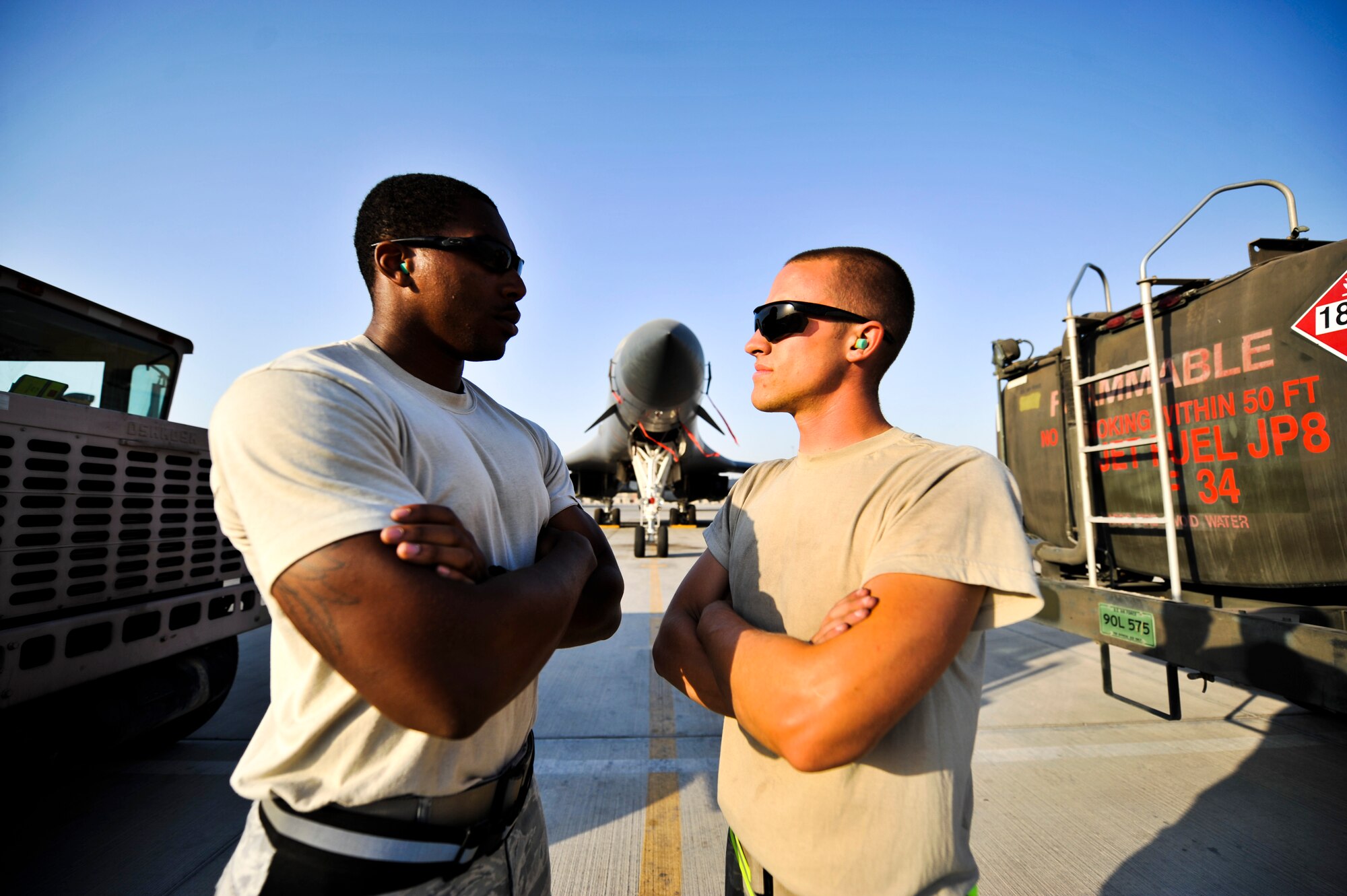 Senior Airman Bryan Winterstein (right), 379th Expeditionary Logistics Readiness Squadron fuel distribution operator, and Senior Airman Marcus Holden, 379th ELRS fuel distribution operator,  double pump  fuel into an aircraft Oct. 23, 2011, at an undisclosed location in Southwest Asia. The pair held a friendly competition in September and combined to pump more than 3.2 million gallons of fuel. Winterstein edged out Holden by less than 12,000 gallons. Winterstein, a native of Joliet, Ill., is deployed from Scott Air Force Base, Ill. Holden, a native of Fort Valley, Ga., is deployed from Joint Base McGuire-Dix-Lakehurst, N.J. (U.S. Air Force photo/Senior Airman Paul Labbe)