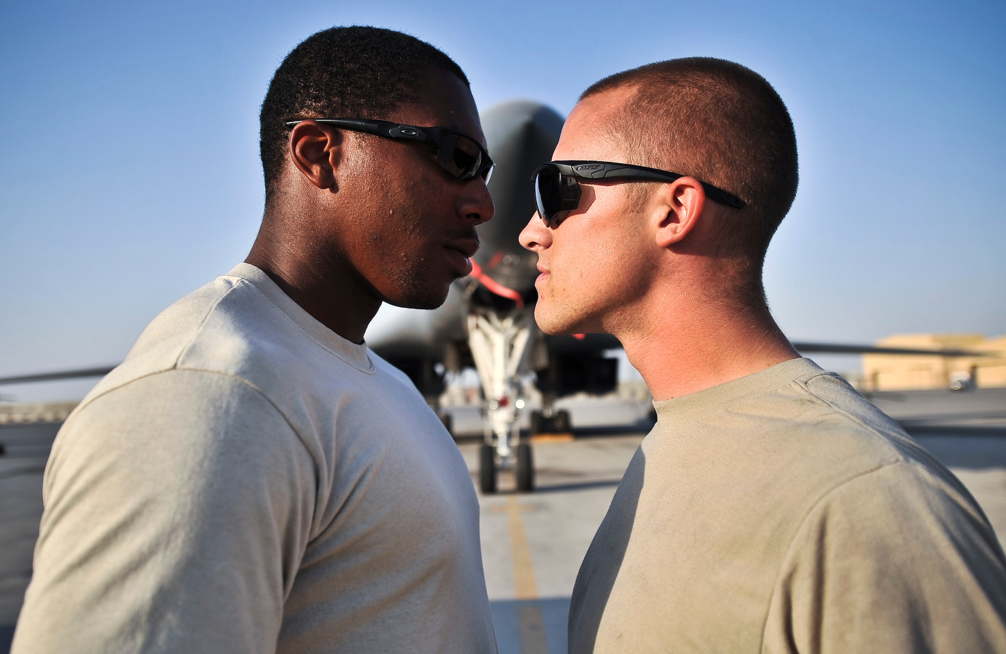 Senior Airman Bryan Winterstein (right), 379th Expeditionary Logistics Readiness Squadron fuel distribution operator, and Senior Airman Marcus Holden, 379th ELRS fuel distribution operator,  double pump  fuel into an aircraft Oct. 23, 2011, at an undisclosed location in Southwest Asia. The pair held a friendly competition in September and combined to pump more than 3.2 million gallons of fuel. Winterstein edged out Holden by less than 12,000 gallons. Winterstein, a native of Joliet, Ill., is deployed from Scott Air Force Base, Ill. Holden, a native of Fort Valley, Ga., is deployed from Joint Base McGuire-Dix-Lakehurst, N.J. (U.S. Air Force photo/Senior Airman Paul Labbe)
