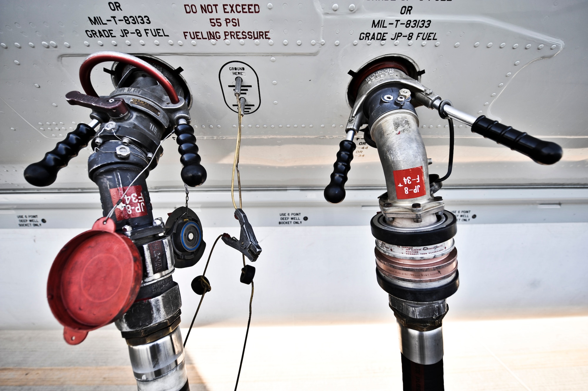 Two refueling hoses attached to the side of an aircraft allow 379th Expeditionary Logistics Readiness Squadron fuel distribution operators to double pump Oct., 23, 2011, at an undisclosed location in Southwest Asia. (U.S. Air Force photo/Senior Airman Paul Labbe)