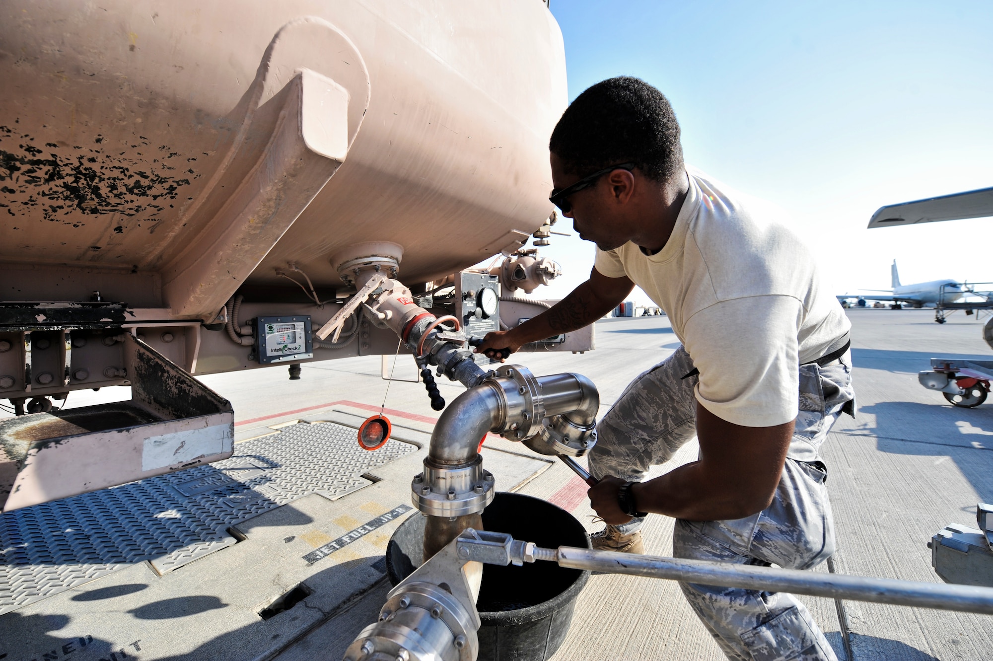 Senior Airman Marcus Holden, 379th Expeditionary Logistics Readiness Squadron fuel distribution operator,  attaches a refueling hose to his truck before heading out to refuel an aircraft Oct. 23, 2011, at an undisclosed location in Southwest Asia. Holden, a native of Fort Valley, Ga., is deployed from Joint Base McGuire-Dix-Lakehurst, N.J. (U.S. Air Force photo/Senior Airman Paul Labbe)