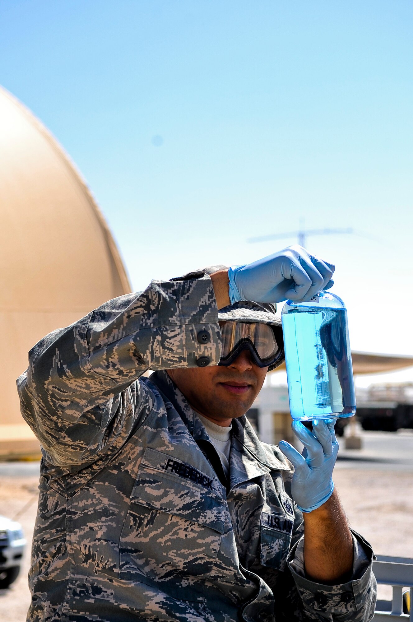 Staff Sgt. James Frederick, 379th Expeditionary Logistics Readiness Squadron fuel lab technician, inspects a container of aviation fuel for particle contamination Oct. 23, 2011, at an undisclosed location in Southwest Asia. Frederick, a native of Bolingbrook, Ill., is deployed from Andersen Air Force Base, Guam. (U.S. Air Force photo/Senior Airman Paul Labbe)