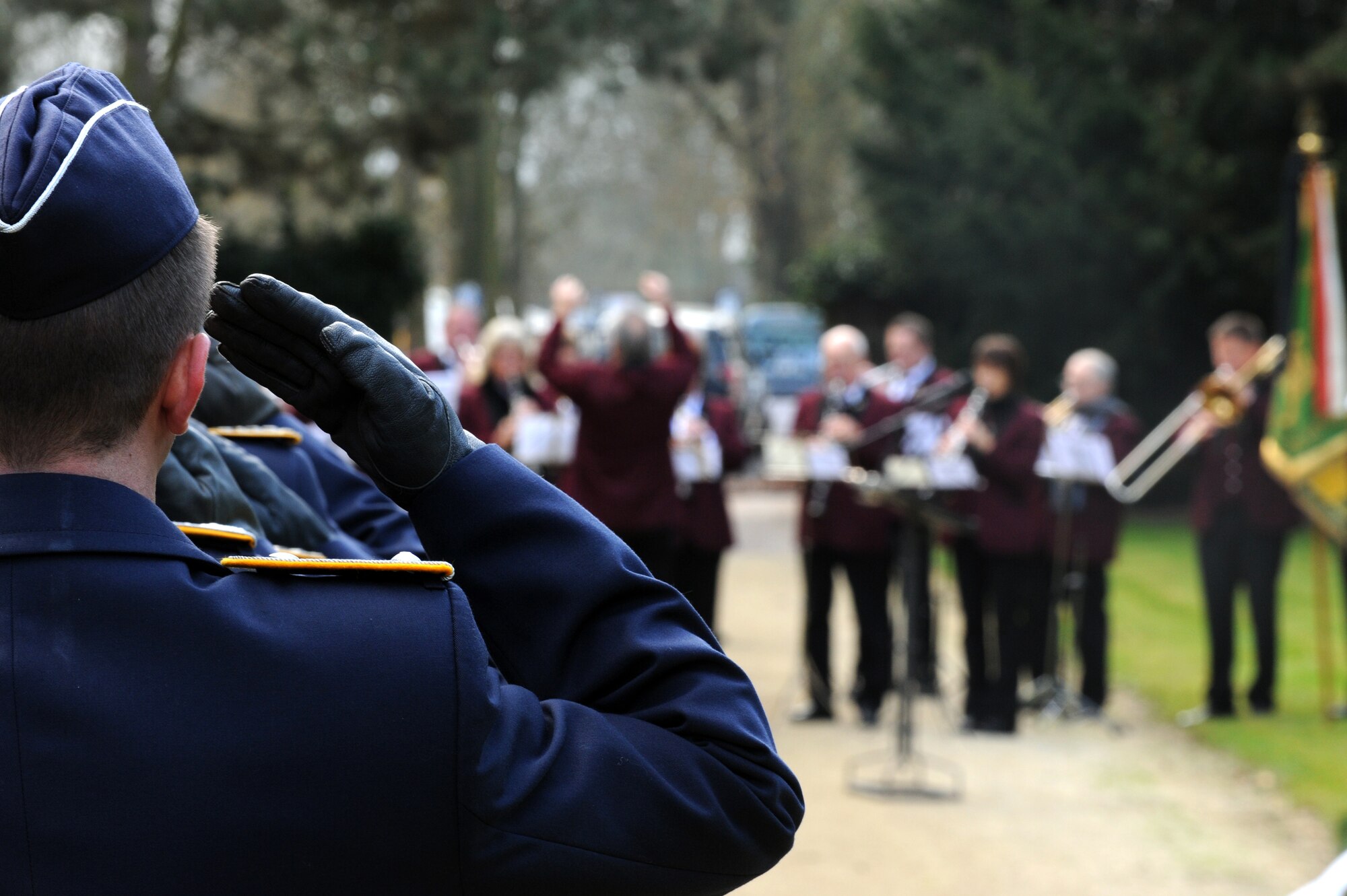 TRIER, Germany – German service members salute as the French, American and German national anthems are played during a wreath laying ceremony for Volkstrauertag, or German Day of National Mourning, at the Trier main cemetery Nov. 13. Members of the 52nd Fighter Wing were invited to participate in the ceremony to remember German victims of war and tyranny. (U.S. Air Force photo/Airman 1st Class Matthew B. Fredericks)