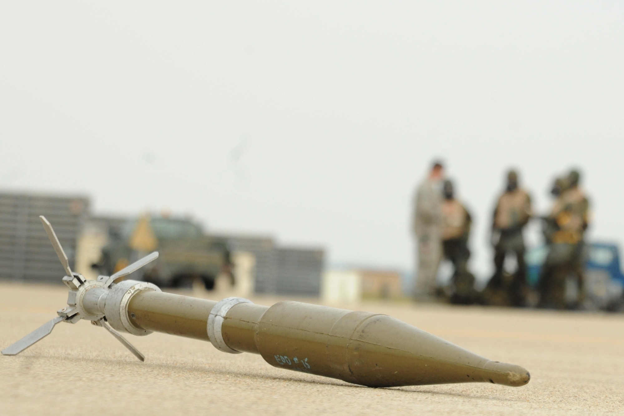 Members of the 8th Maintenance Group spot an UXO during an ability to survive and operate rodeo at Kunsan Air Base, Republic of Korea, Nov. 10. Airmen were evaluated in four man teams during 12 events, including transitioning from MOPP 0 to MOPP 4, self-aid buddy care, signs and counter signs, contaminated vehicles and stanchions. Each event was timed and graded as go-no on a 60 and 100 point scale. The team with the highest score and fastest time received a free pass. (U.S. Air Force photo by Senior Airman Brittany Y. Auld/Released)