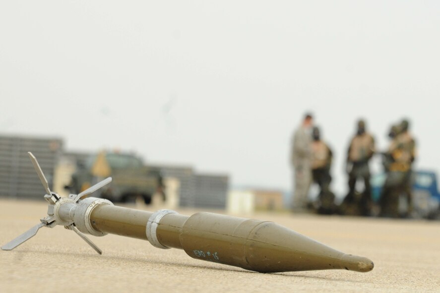 Members of the 8th Maintenance Group spot an UXO during an ability to survive and operate rodeo at Kunsan Air Base, Republic of Korea, Nov. 10. Airmen were evaluated in four man teams during 12 events, including transitioning from MOPP 0 to MOPP 4, self-aid buddy care, signs and counter signs, contaminated vehicles and stanchions. Each event was timed and graded as go-no on a 60 and 100 point scale. The team with the highest score and fastest time received a free pass. (U.S. Air Force photo by Senior Airman Brittany Y. Auld/Released)