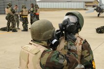 Members of the 8th Maintenance Group check each other’s chemical suits to ensure proper fit during an ability to survive and operate rodeo at Kunsan Air Base, Republic of Korea, Nov. 10. Airmen were evaluated in four man teams during 12 events, including transitioning from MOPP 0 to MOPP 4, self-aid buddy care, signs and counter signs, contaminated vehicles and stanchions. Each event was timed and graded as go-no on a 60 and 100 point scale. The team with the highest score and fastest time received a free pass. (U.S. Air Force photo by Senior Airman Brittany Y. Auld/Released)