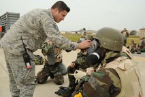 Staff Sgt. Ryan Merrigan, 8th Maintenance Group exercise evaluation team member, evaluates Airmen during an ability to survive and operate rodeo at Kunsan Air Base, Republic of Korea, Nov. 10. Airmen were evaluated in four man teams during 12 events, including transitioning from MOPP 0 to MOPP 4, self-aid buddy care, signs and counter signs, contaminated vehicles and stanchions. Each event was timed and graded as go-no on a 60 and 100 point scale. The team with the highest score and fastest time received a free pass. (U.S. Air Force photo by Senior Airman Brittany Y. Auld/Released)