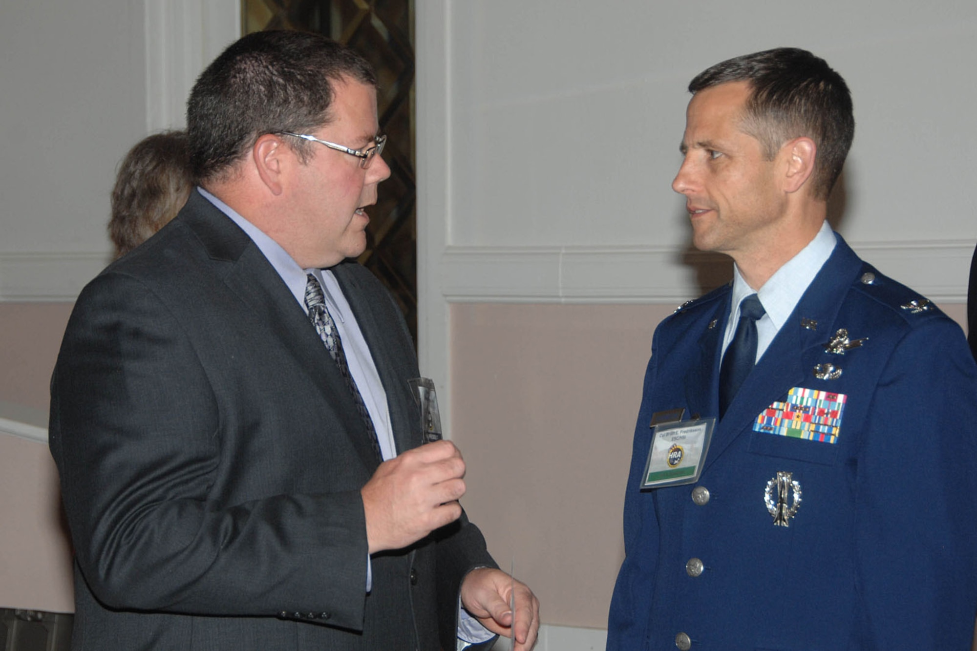 HANSCOM AIR FORCE BASE, Mass. - Tom Portlock (left), Hanscom Representatives Association president, speaks with Col. Brian Fredriksson, system program manager for Space Surveillance and Command and Control, during the HRA meeting Nov. 8 at Hanscom's Minuteman Commons. Fredriksson was the keynote speaker and provided an overview on work done in his division, business opportunities and the future of space programs. (U.S. Air Force photo by Linda LaBonte Britt)