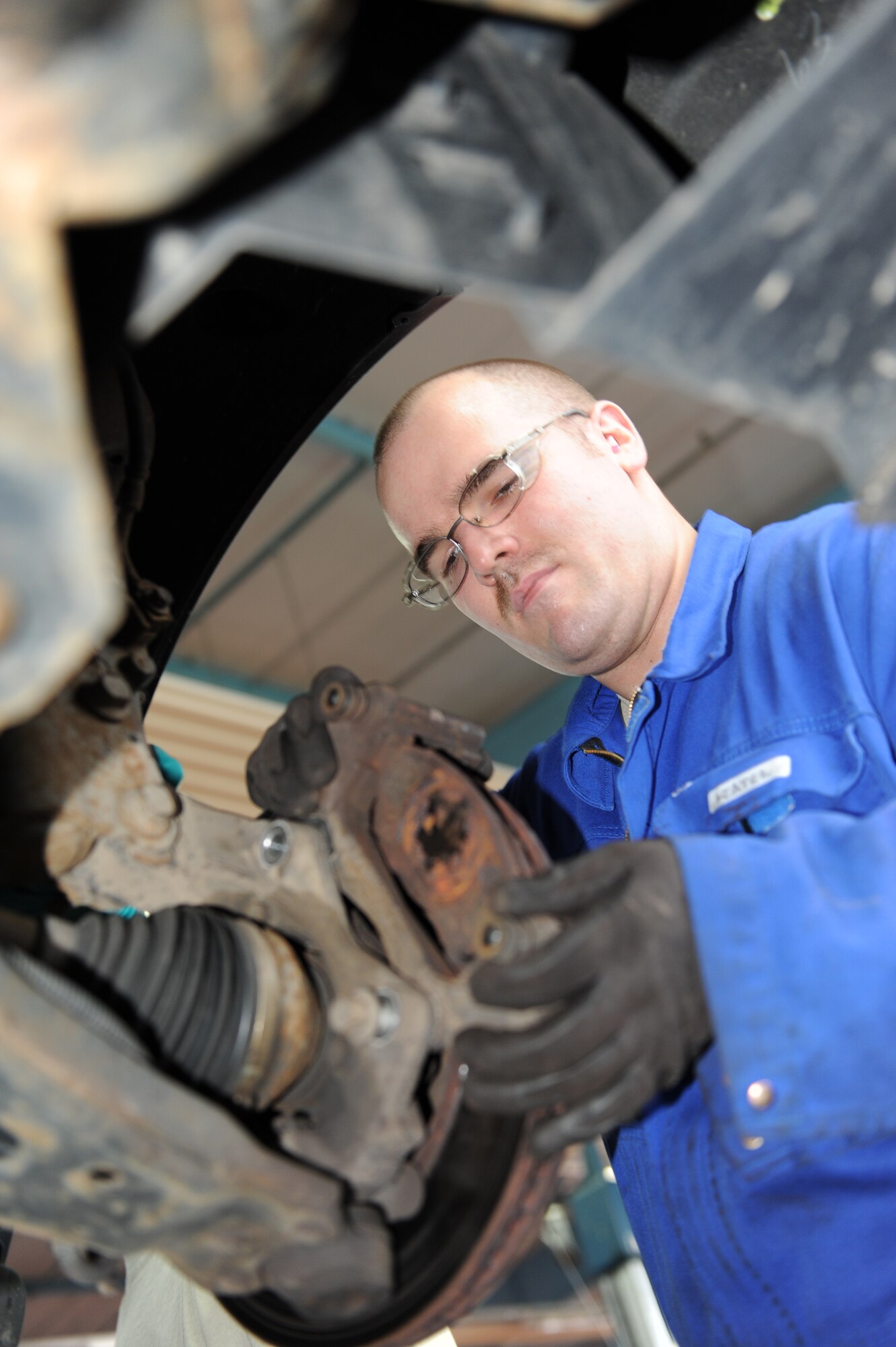 SPANGDAHLEM AIR BASE, Germany – Senior Airman Jeremy Yeater, 52nd Logistics Readiness Squadron vehicle equipment maintainer, takes the caliper mount off a government vehicle’s wheel hub during an inspection of an anti-lock breaking system here Nov. 9. The 52nd LRS Vehicle Maintenance Flight is responsible for servicing all of the government vehicles on base to ensure Spangdahlem is mission ready. (U.S. Air Force photo/Senior Airman Christopher Toon)