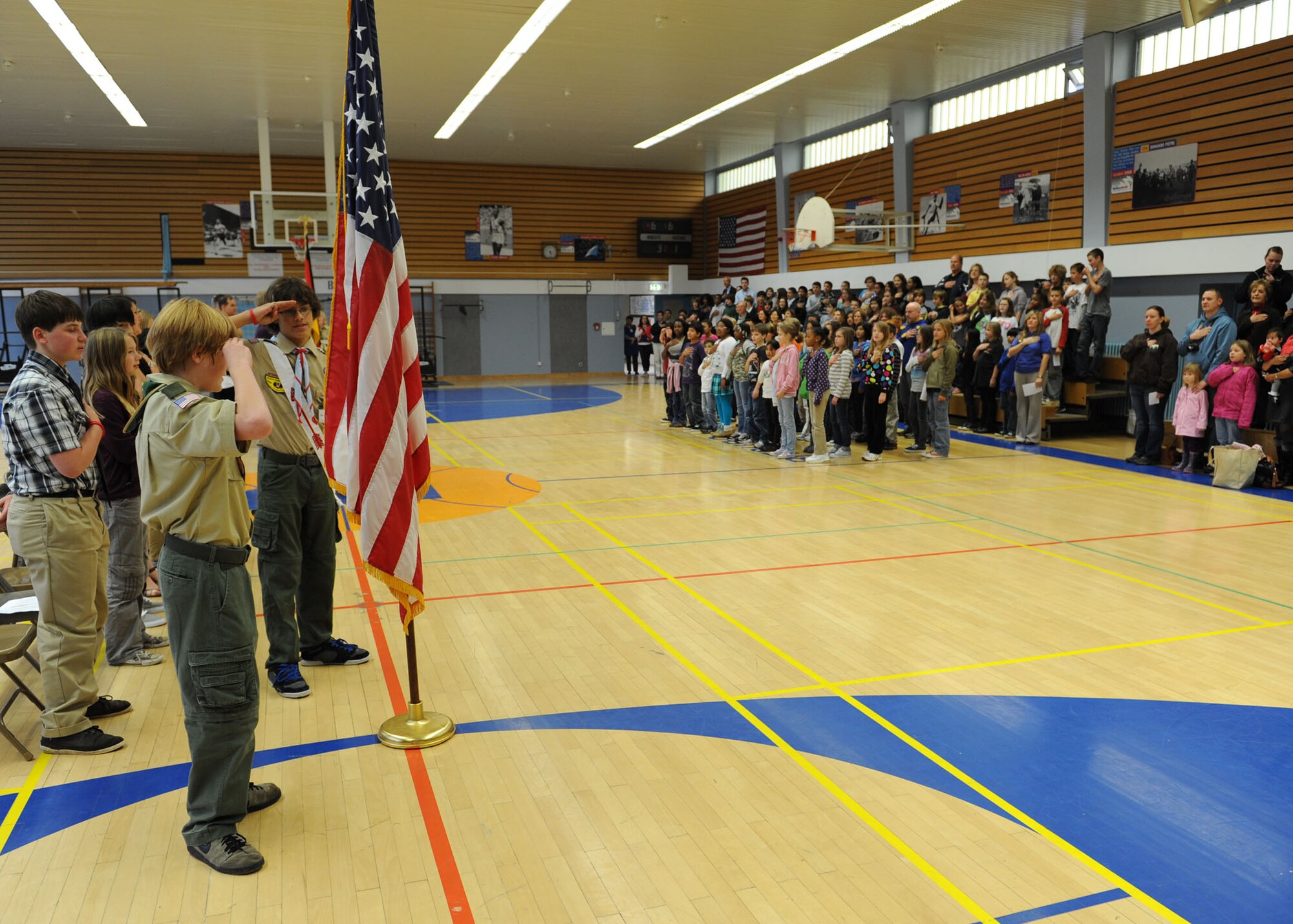 BITBURG ANNEX, Germany – Students pay respect to the American flag during the Pledge of Allegiance at a Veterans Day ceremony at Bitburg Middle School Nov. 9. Veterans Day is an annual U.S. holiday honoring military veterans who have served in the military past and present. (U.S. Air Force photo/Senior Airman Christopher Toon)