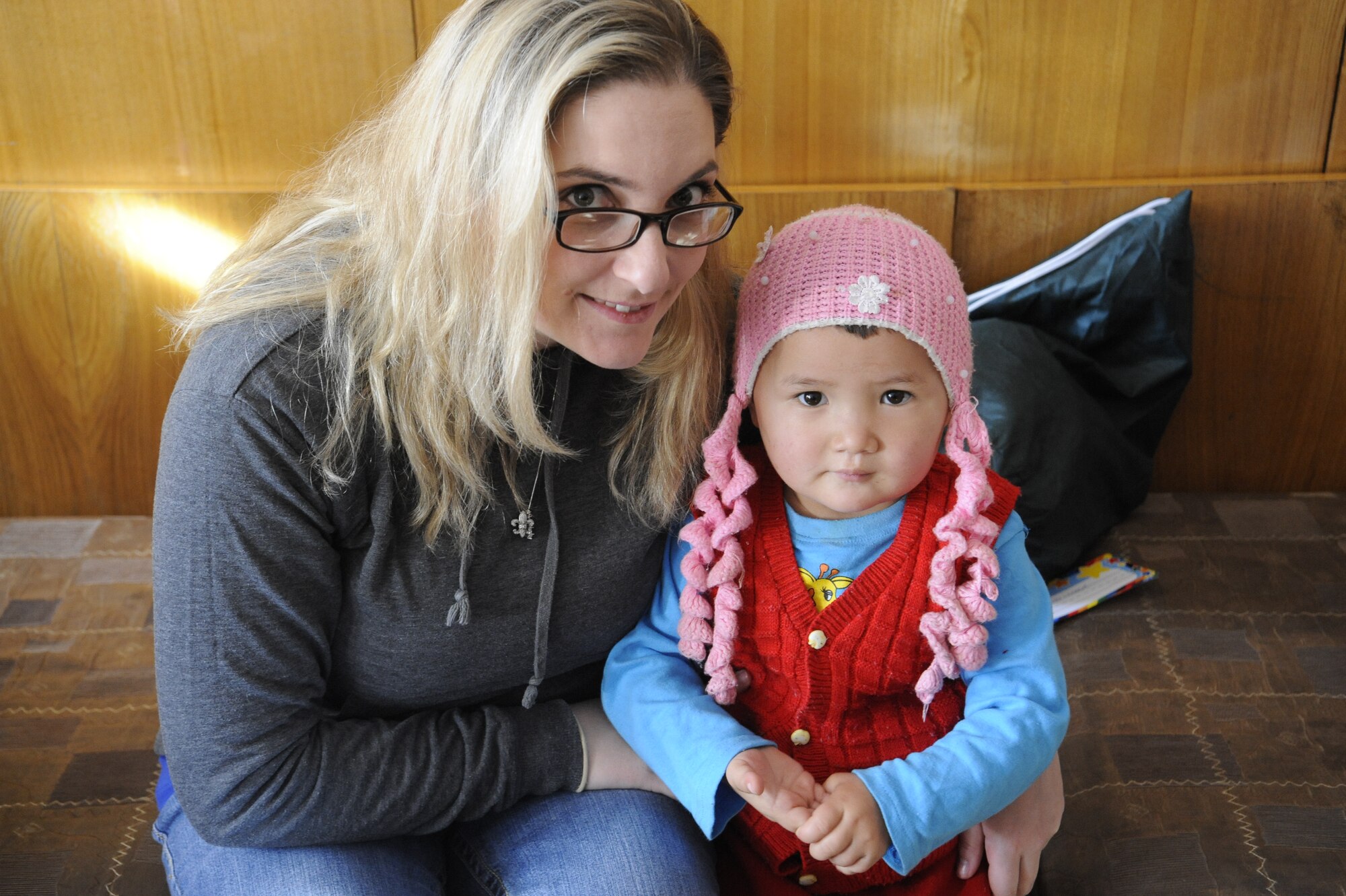 Staff Sgt. Jena Taylor poses for a photo with a child awaiting heart surgery at the Children's Heart Ward of the Kyrgyz Scientific Research Institute of Heart Surgery and Organ Transplantation in Bishkek, Kyrgyzstan, Nov. 11. Airmen at the Transit Center at Manas have volunteered more than 50,000 hours, which have been invested to Kyrgyz organizations and charities through the Manas Area Benefit Outreach Society since 2003. Taylor is the MABOS heart ward focus group leader. She is deployed to the Transit Center as an 817th Expeditionary Airlift Squadron combat crew communications specialist from Joint Base Lewis-McChord, Wash. She is a native of Gilroy, Calif. (U.S. Air Force photo/Tech. Sgt. Tammie Moore)