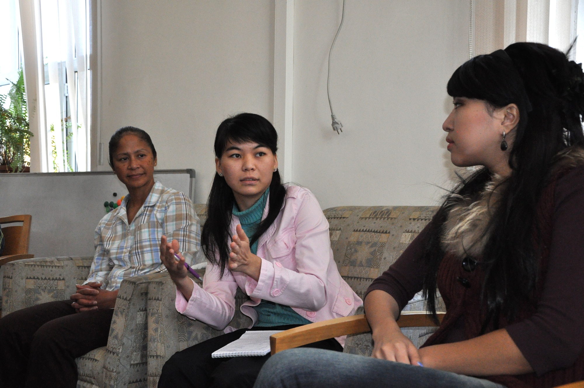 Asel Emilkanova, middle, answers questions from an American service member deployed to the Transit Center at Manas, Kyrgyzstan, during an American Corner's: Women's Club in Bishkek, Oct. 21, 2011. Emilkanova is 22 and lived in the United States for three months once. To her left is Chief Master Sgt. Arleen Heath, 376th Air Expeditionary Wing command chief, who participated in the Women's Club for the first time and talked about her experience as a female in the military. 