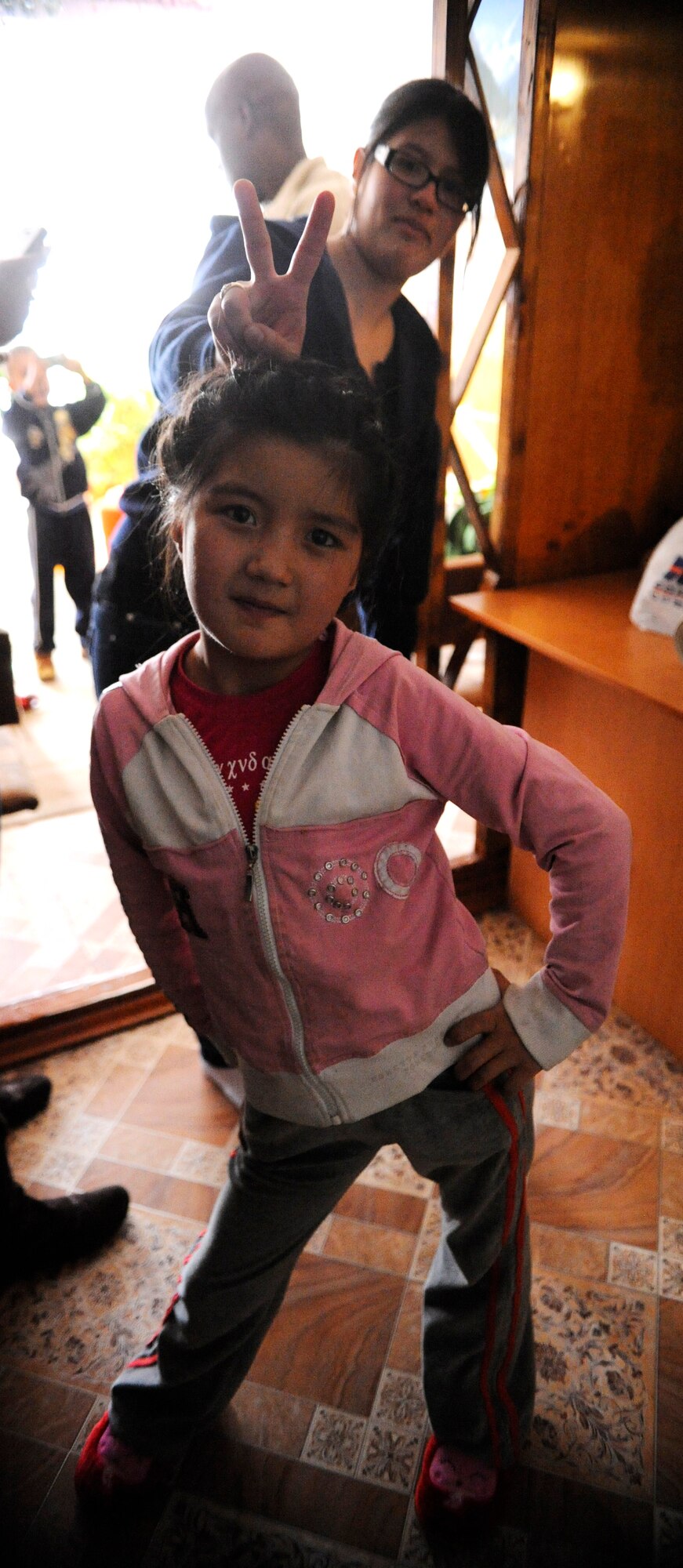 Airman 1st Class Juliana Guzman gives bunny ears as a Kyrygz child poses for a photo at the Children's Heart Ward of the Kyrgyz Scientific Research Institute of Heart Surgery and Organ Transplantation in Bishkek, Kyrgyzstan, Nov. 11. The girl is one of 20 children awaiting heart surgery at the hospital. Guzman is a member of the Manas Area Benefit Outreach Society. Airmen at the Transit Center at Manas have volunteered more than 50,000 hours, which have been invested to Kyrgyz organizations and charities through MABOS since 2003. Guzman is deployed to the Transit Center as a 376th Expeditionary Force Support Squadron quality assurance specialist from Air National Guard’s 146th Air Wing, Channel Islands , Calif. (U.S. Air Force photo/Tech. Sgt. Tammie Moore)