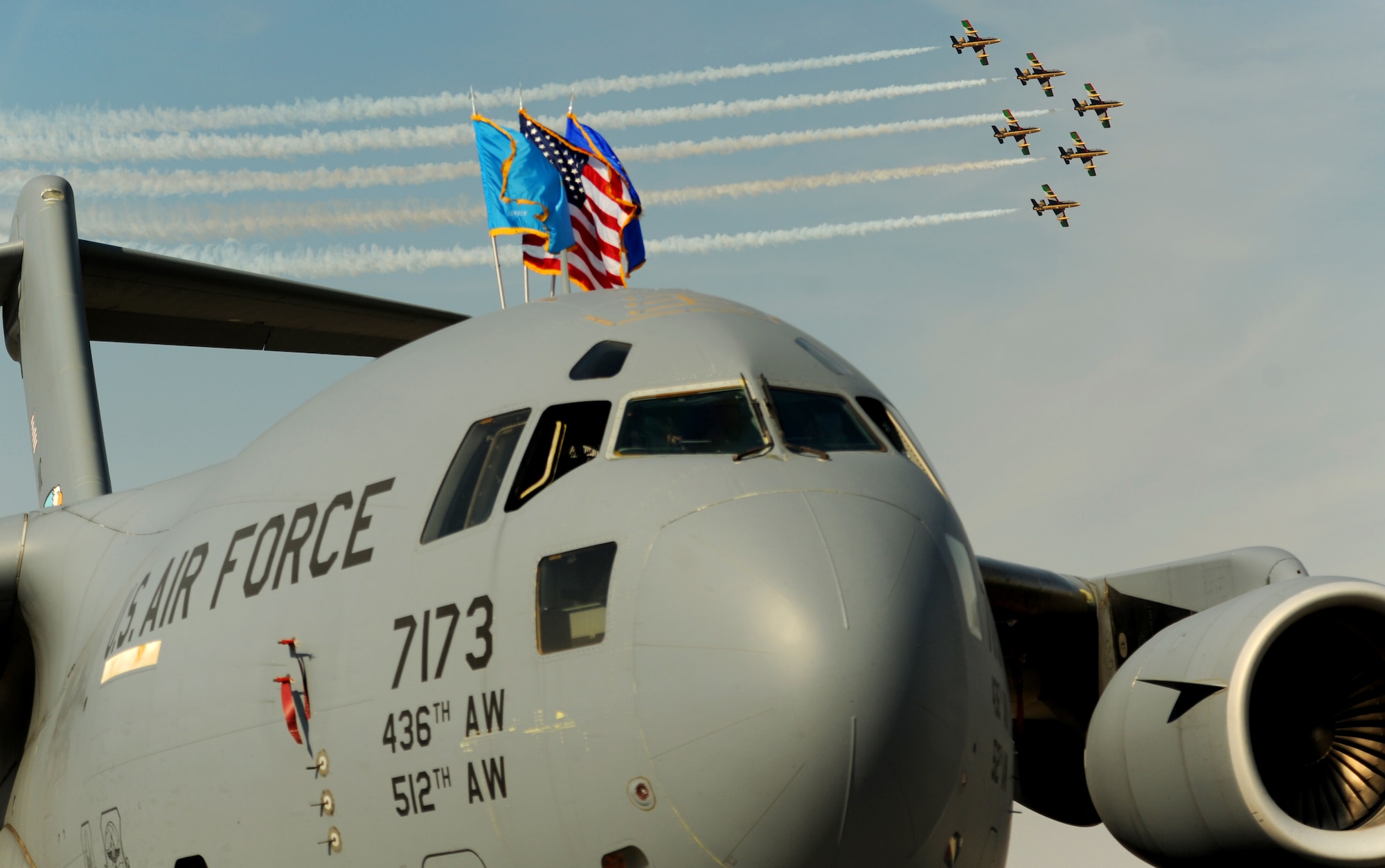 An aerobatic team flies over a C-17 Globemaster at the city's Airport Expo Nov. 13, 2011, Dubai, United Arab Emirates. This year the static displays will be the C-17 Globemaster, C-130 Hercules, E2-C Hawkeye, F-15C Eagle, F-16 Fighting Falcon, F-18 Hornet, MH-60R Seahawk, and V-22 Osprey. The event demonstrates a shared commitment both to regional security and to developing our key relationships throughout Southwest Asia. (U.S. Air Force photo by Tech. Sgt. Rey Ramon)