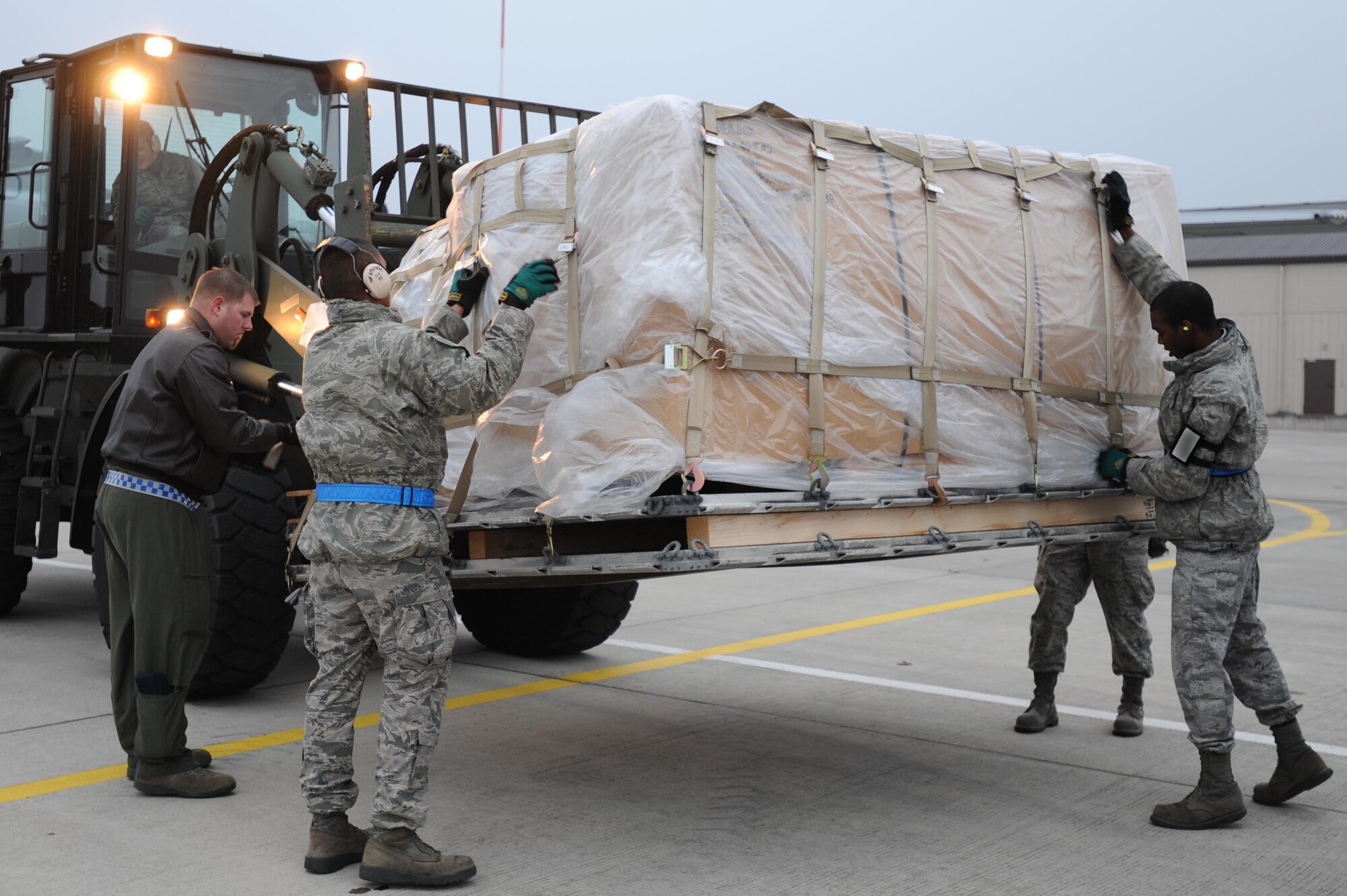 Members of the 86th Aircraft Maintenance Squadron secure pallets of humanitarian supplies before transportation, Ramstein Air Base, Nov. 13, 2011. The effort is in support of the Turkey-led relief efforts following the Oct. 23, 2011, earthquake in Van province, Turkey. At the request of the Turkish government the Department of Defense has tasked U.S. European Command to airlift relief supplies to Van province. (U.S. Air Force Photo by Airman 1st Class Caitlin O?Neil-McKeown) 