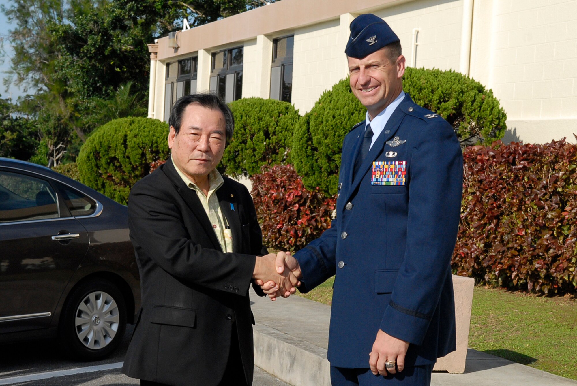 Col. Corey Martin, 18th Wing vice commander, welcomes Yasuo Ichikawa, Japanese Minister of Defense, to Kadena Air Base, Japan, before a briefing and tour of the base Nov. 12, 2011. The minister's visit to Kadena was to discuss matters concerning the Okinawan people, the mission of the 18th Wing and to be shown first-hand the operations of Kadena during a tour of the flight line. (U.S. Air Force photo by Airman 1st Class Tara A. Williamson/released)