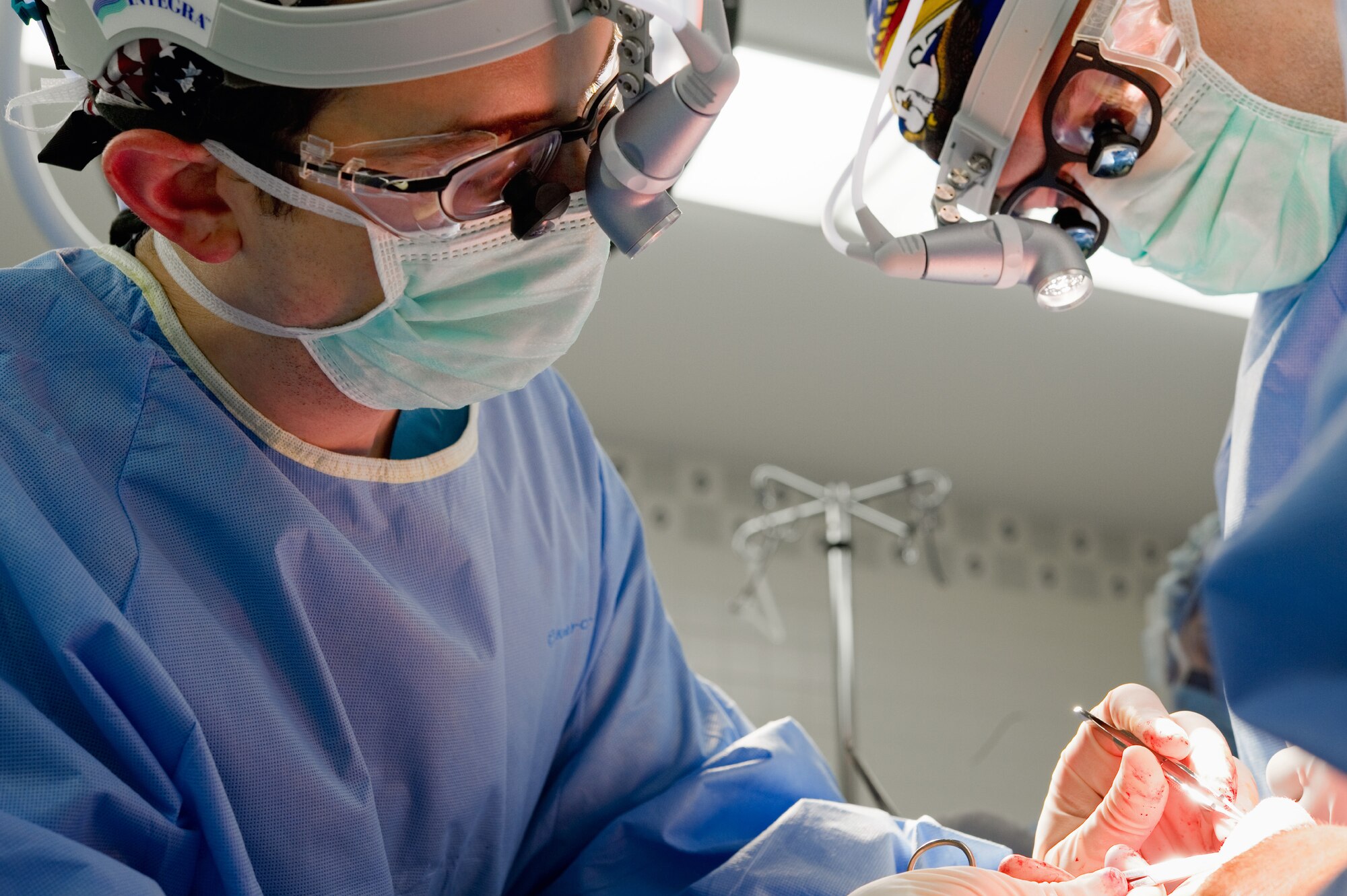 YOKOTA AIR BASE, Japan Capt. Scott McCusker (left), Chief Otolaryngologist, and Capt. Leland Webb (right), General Surgeon, both from the 374th Surgical Operations Squadron, secure cartilage grafts during a septorhinoplasty, , a procedure performed to reconstruct a nasal passage and improve a patients breathing by reconstructing the cartilaginous and bony structure of the nose, at Yokota's base hospital, Nov. 9, 2011. The 374th MSGS performs 15 to 20 procedures per month. (U.S. Air Force photo/Osakabe Yasuo)