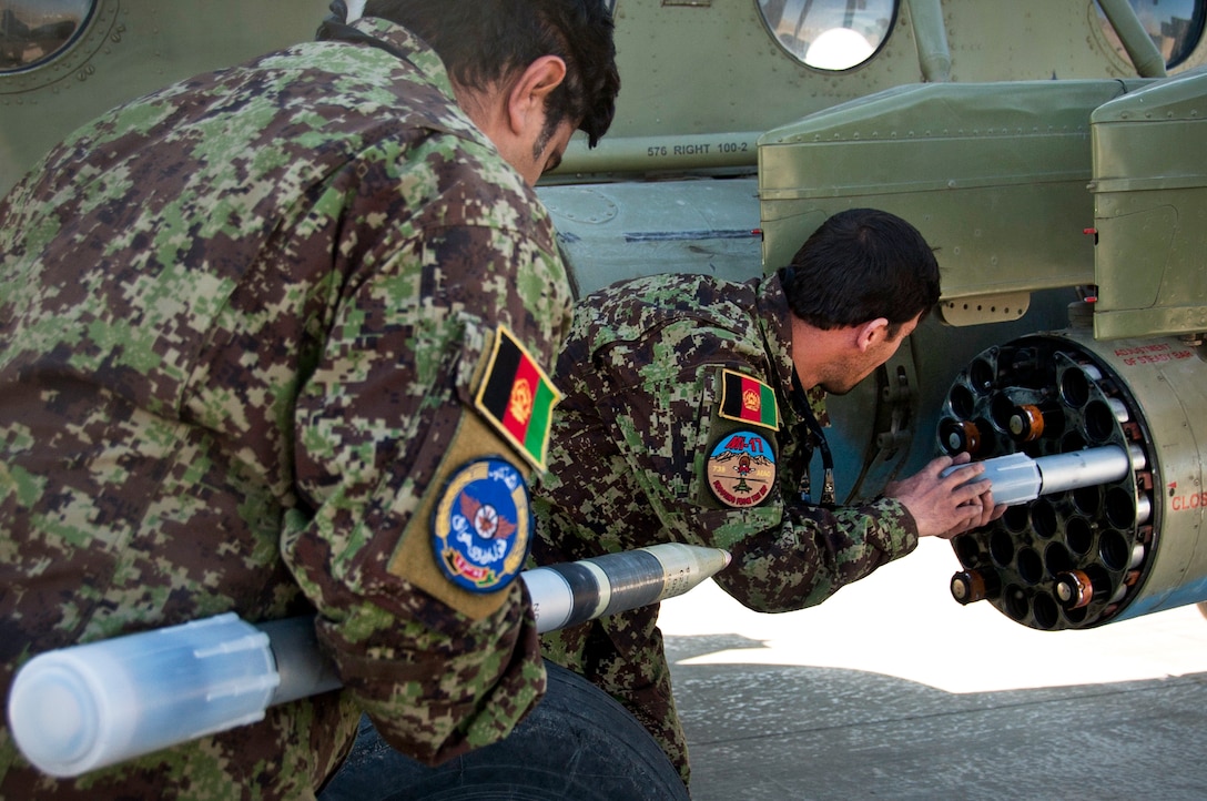 Afghan airmen load a Mi-17 helicopter with 57 mm S5 rockets on Kandahar Airfield, Afghanistan, Nov. 13, 2011. The Afghan air force has been performing rocket training since March 2011.