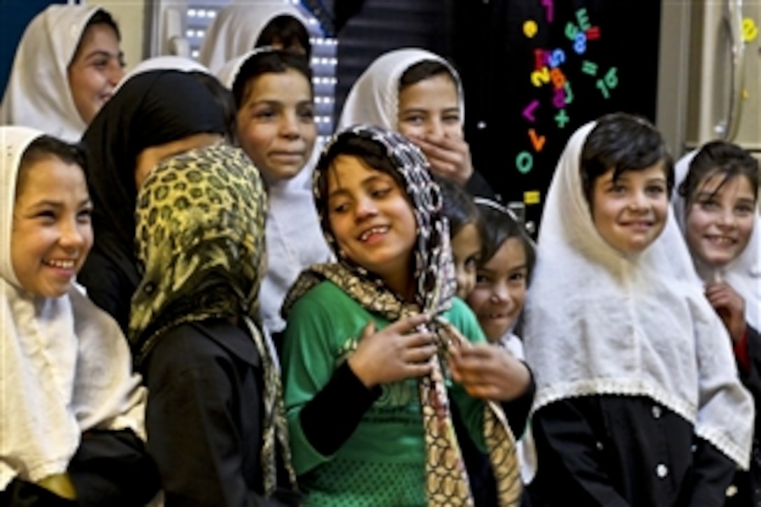 Afghan girls assemble to take their first class photo at The Cat in the Hat Language Arts Center, a new school on Bagram Airfield, Afghanistan, Nov. 13, 2011. The U.S. Army runs the school, which helps teach students English.