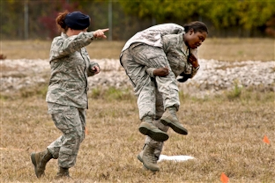 Airman 1st Class Nikili Carter, of the 307th Security Forces Squadron, uses the fireman carry technique on a teammate during the mental and physical competition during Global Strike Challenge 2011 on Barksdale Air Force Base, La., Nov. 7, 2011. Teams competing in the event were not allowed to know the details of the competition, which included grueling physical and logic scenarios.