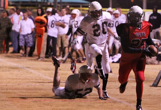 A player with HQBN Bulldawg sneaks past MCCES Mustang defense to score a touchdown Nov. 15, 2011 at Felix Field.