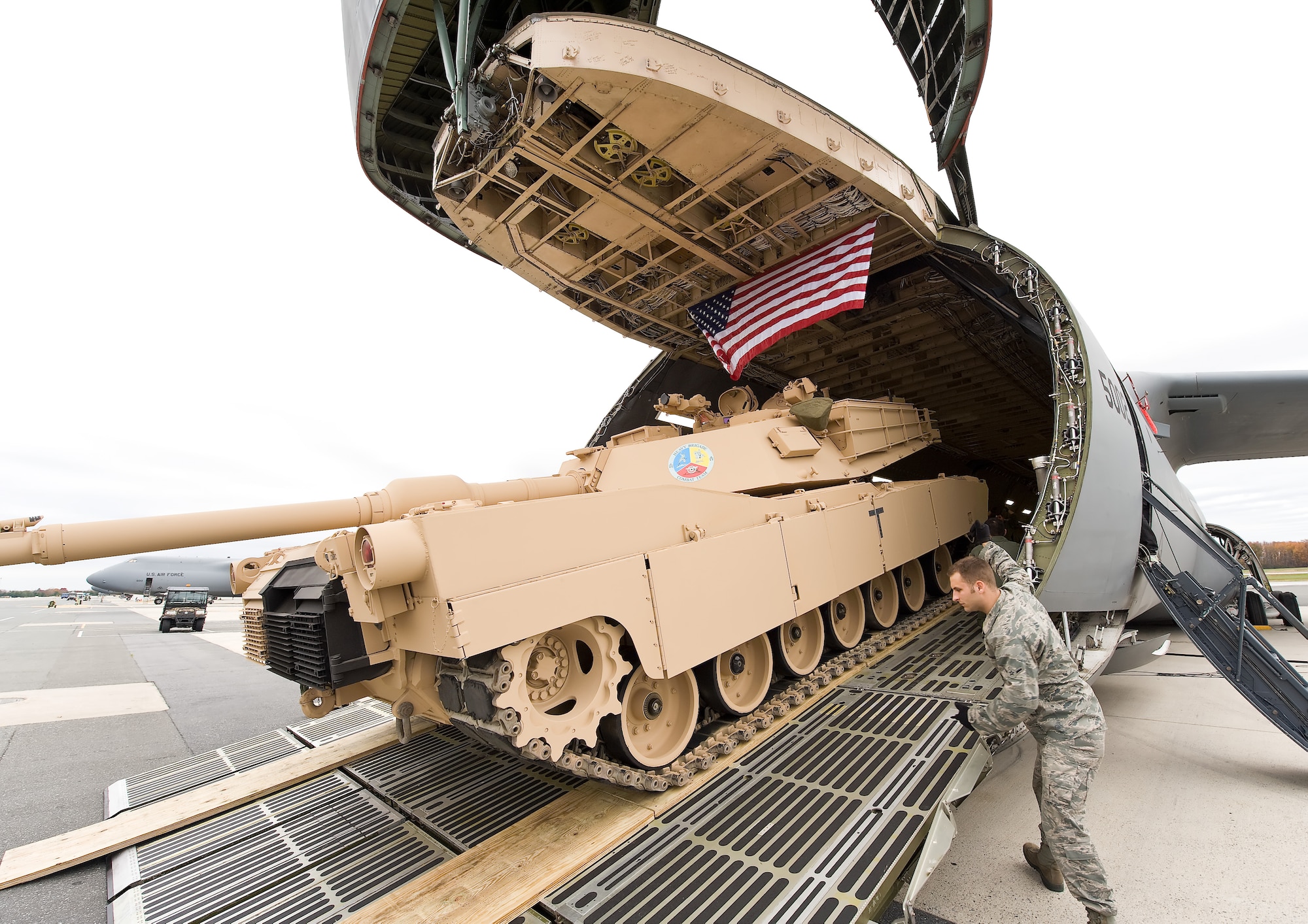 A loadmaster directs an M1 Abrams tank into a C-5M Super Galaxy Nov. 15, 2011, at Dover Air Force Base, Del. (U.S. Air Force photo by Roland Balik)