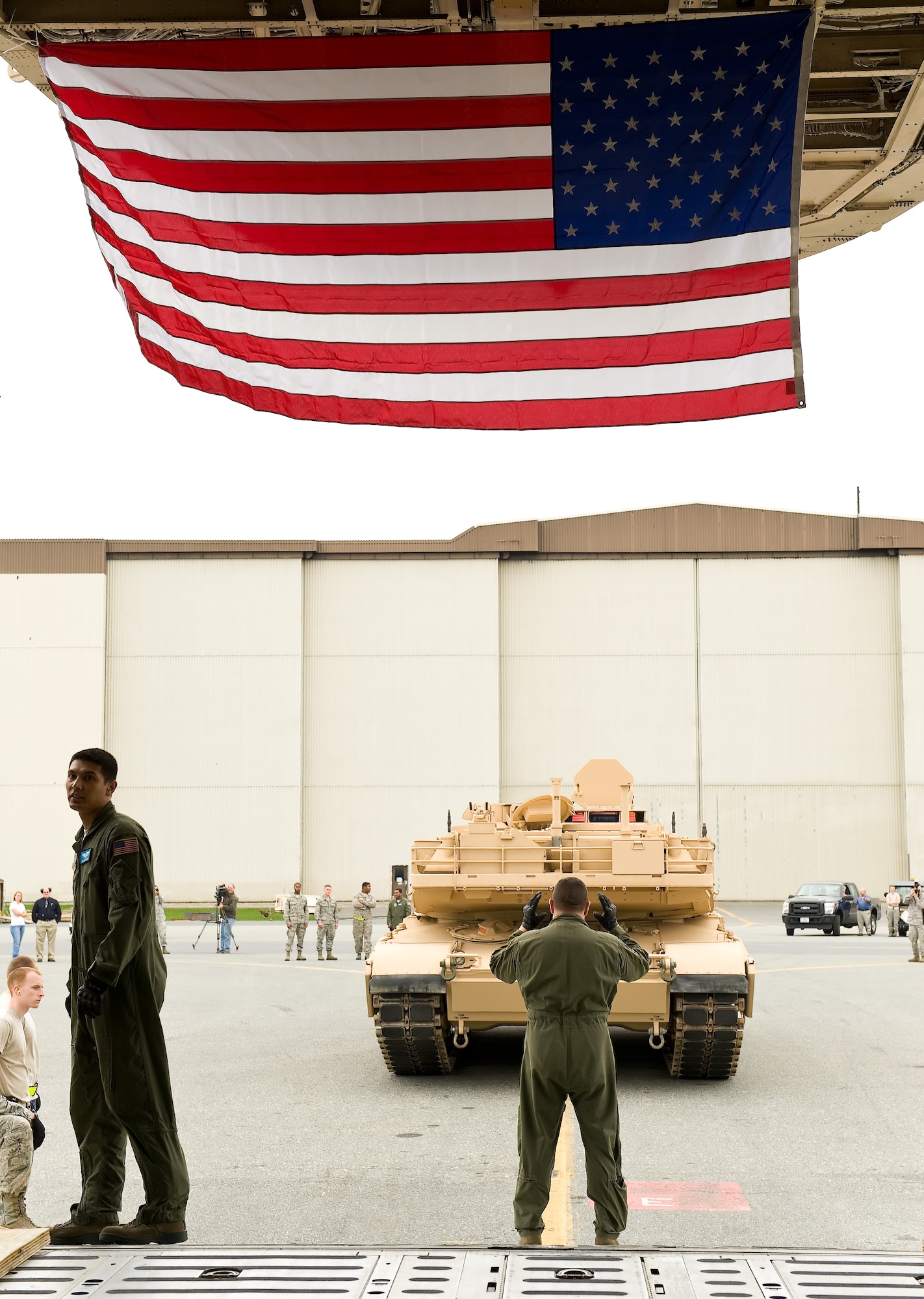 An M1 Abrams tank is marshaled into a C-5M Super Galaxy Nov. 15, 2011, at Dover Air Force Base, Del. (U.S. Air Force photo by Roland Balik)