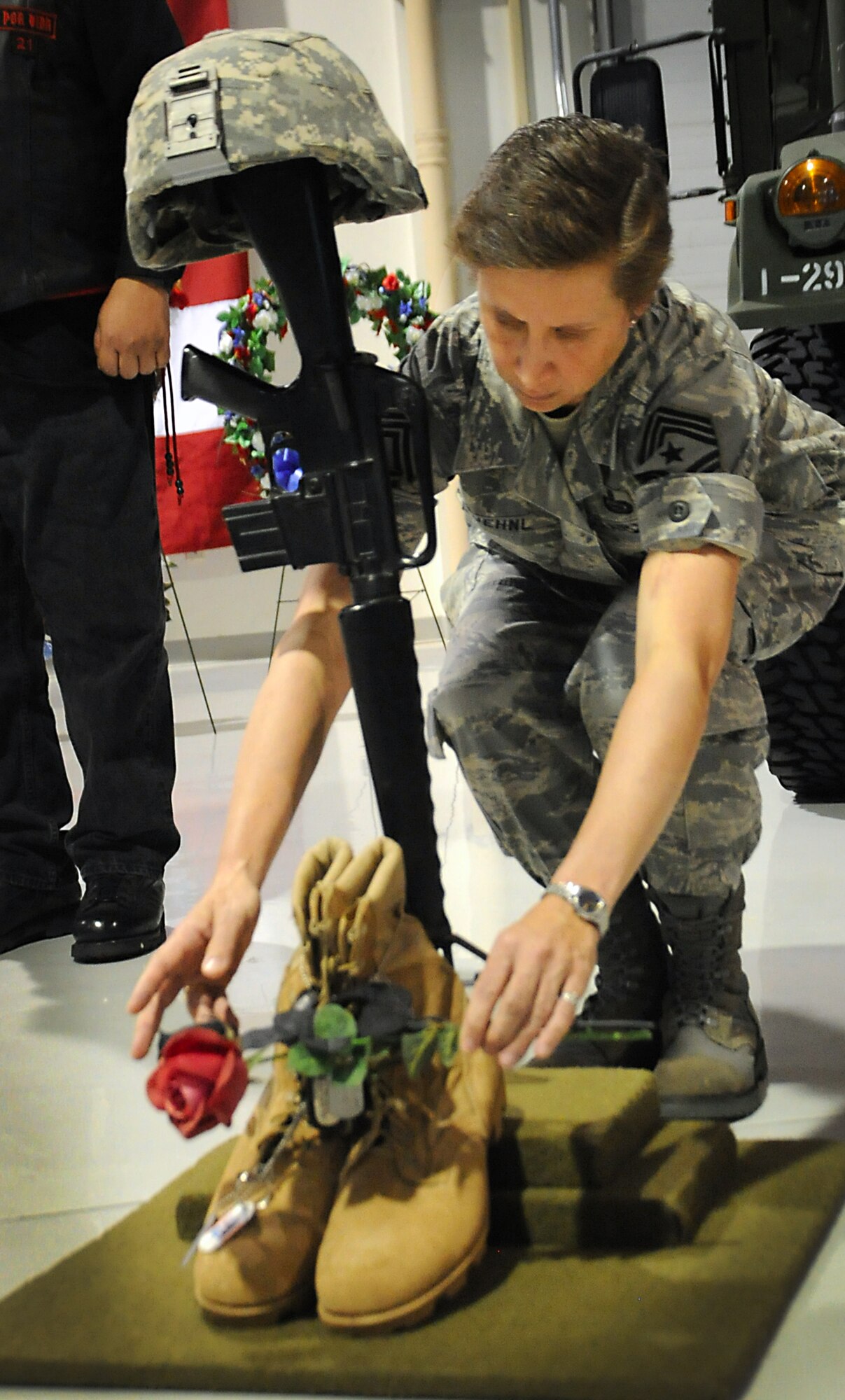 JOINT BASE ELMENDORF-RICHARDSON, Alaska -- Command Chief Master Sgt. Lisa Kuehnl pays her respects during Veterans and Remembrance Day at the Alaska National Guard armory, Joint Base Elmendorf-Richardson, Alaska Nov. 11, 2011. The first remembrance day was conducted in 1919 throughout the British Commonwealth. Kuehnl is the 673rd senior advisor on all matters enlisted. (U.S. Air Force photo/Senior Airman Cynthia Spalding)
