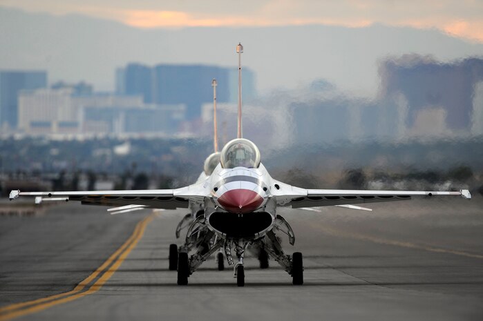 Two "Thunderbirds" pilots taxi in their F-16 aircraft after the completion of the practice air show Nov. 11, 2011, at Nellis Air Force Base, Nev. The team was getting ready for its headlining performance at "Aviation Nation 2011," the base's annual open house and largest free event in the state. (U.S. Air Force photo/Staff Sgt. Larry E. Reid Jr.)
