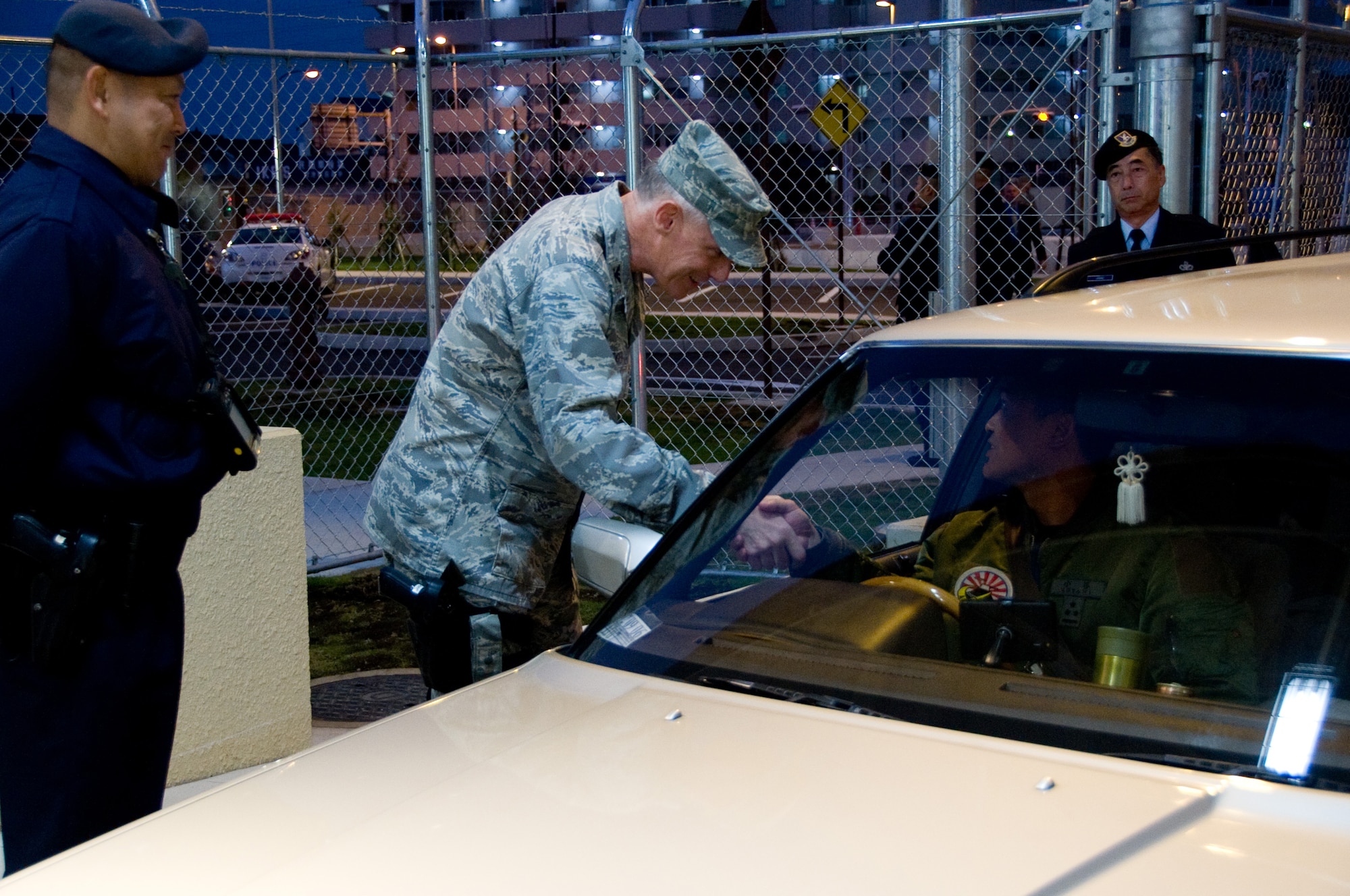 YOKOTA AIR BASE, Japan -- Col. Otto Feather, 374th Airlift Wing commander, checks the ID card of the first person to drive through the newly built supply gate at Yokota Air Base, Japan, Nov. 14, 2011. This nine month long project combined Pass and Id with the supply gate. (U.S. Air Force photo/Airman 1st Class Krystal M. Garrett)