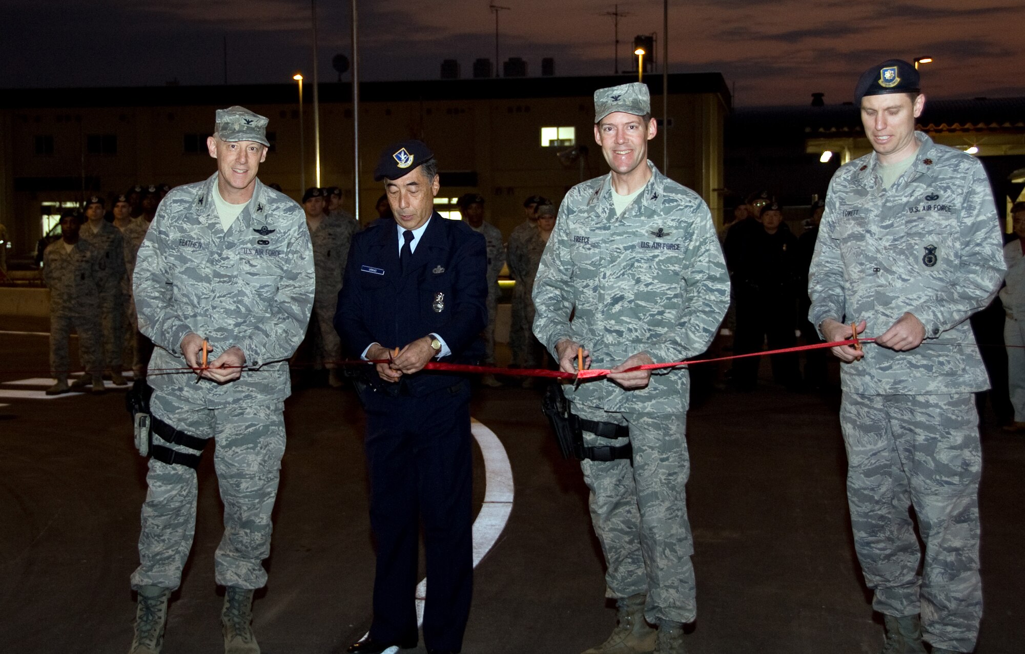 YOKOTA AIR BASE, Japan -- (From left to right) Col. Otto Feather, 374th Airlift Wing commander, Akihiro Urano, 374th Security Forces patrolman, Col. Todd Freece, 374th Airlift Wing mission support group commander, and Maj. Steven Lovett, 374th Security Forces commander, cuts a ribbon signifying the opening of the newly built supply gate at Yokota Air Base, Japan, Nov. 14, 2011. This nine month long project combined Pass and Id with the supply gate. (U.S. Air Force photo/Airman 1st Class Krystal M. Garrett)