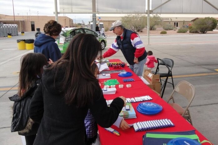 On right, Bob Ostrea, 99th Civil Engineer Squadron Environment Section member, provides key recycling information to families during Aviation Nation Nov. 12-13, 2011, at Nellis Air Force Base, Nev.  Nellis has a number of ongoing recycling programs and will soon begin its Christmas Tree Recycling Program, which takes place during the holiday season.  This year, the Nellis Recycling Center will accept trees between Dec. 26, 2011, and Jan. 15, 2012. (Courtesy photo)