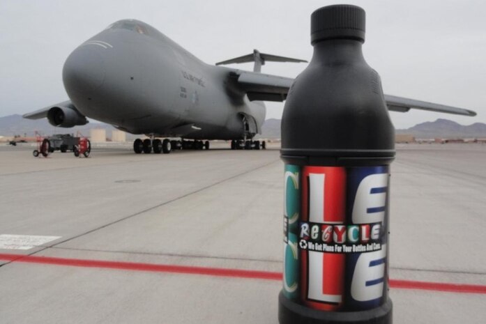 A recycling container resembling a large plastic bottle sits on the flightline during Aviation Nation Nov. 12-13, 2011, at Nellis Air Force Base, Nev.  Personnel from the 99th Civil Engineer Squadron Environmental Section, the 99th Force Support Squadron Marketing Office and the 99 CES Operations Flight placed 20 of these containers around the flightline so that Aviation Nation attendees would be able to recycle their bottles easily throughout the Open House event. (Courtesy photo)
