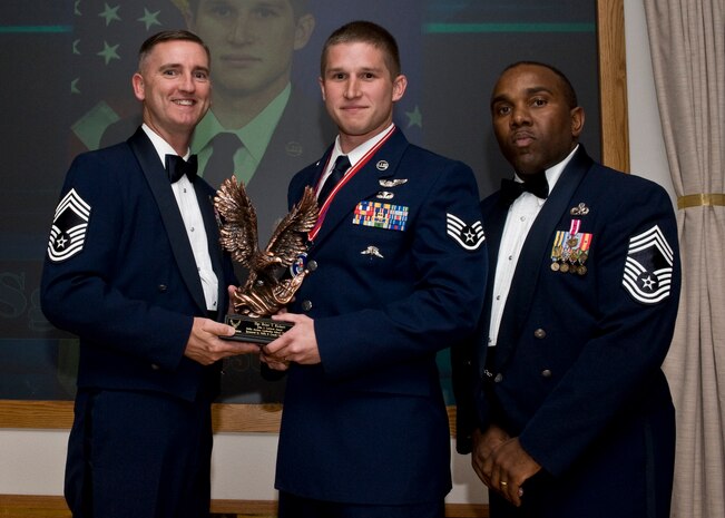 From left, Chief Master Sgt. Brian Watson, 99th Logistics Readiness Squadron chief and Chief's Group representative, and Chief Master Sgt. Randy Bromell, 757th Aircraft Maintenance Squadron chief and Airman Leadership School graduation ceremony guest speaker, present Staff Sgt. Brian Rickert, 58th Rescue Squadron pararescueman, the John. L. Levitow Award Nov. 10, 2011, at the ALS graduation ceremony on Nellis Air Force Base, Nev.  The Levitow Award is the highest award presented at all levels of enlisted Professional Military Education and is given to the top graduate in the class.  (Courtesy photo)