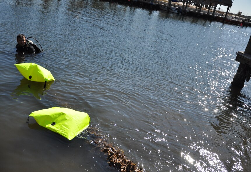 Students from Air Force Special Operations Command Special Tactics Training Squadron, Hurlburt Field, Fla., participate in a cleanup of the Hurlburt Marina Nov. 12, 2011. Volunteers used 100-pound weight bags to clear the waterways of 3,700 pounds of debris.(U.S. Air Force photo/Rachel Arroyo) RELEASED