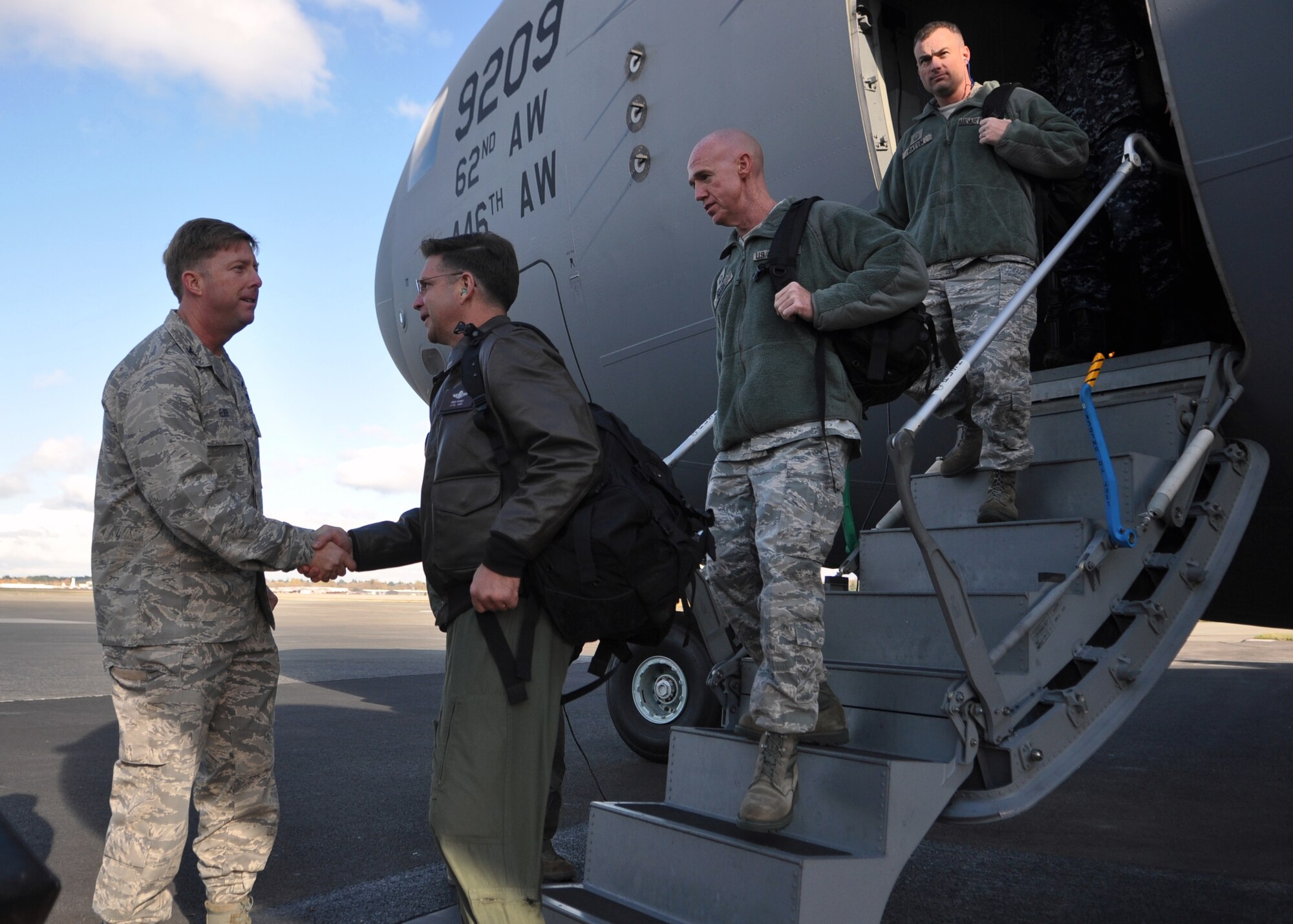 Col. R. Wyn Elder, left, 62nd Airlift Wing commander, greets members of the Nuclear Surety Inspection team as they arrive Nov. 15, 2011, at Joint Base Lewis-McChord, Wash. During the inspection, which takes place Nov. 15 – 21, teams will evaluate the six major graded areas of the wing's Nuclear Surety Program: management and administration; personnel reliability program; tools, test, tiedown and handling equipment; safety; emergency exercises and logistics movement. The 62nd AW's Nuclear Surety Program has won an Air Mobility Command and Air Force Safety Award 12 of the last 13 years. (U.S. Air Force photo/Airman 1st Class Leah Young)