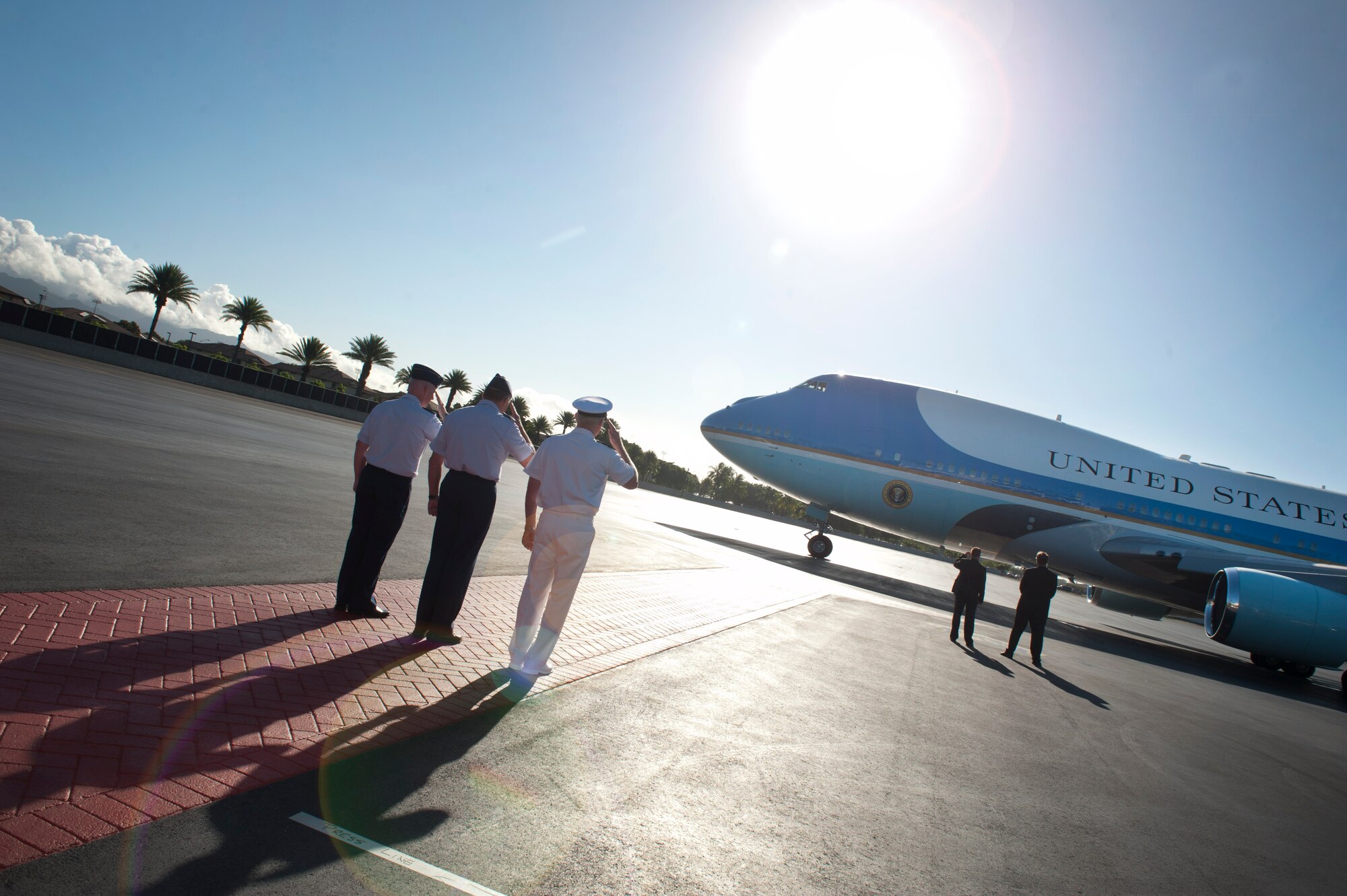 Admiral Robert Willard, (right) U.S. Pacific Command commander, Gen. Gary North, (middle) Pacific Air Forces commander, and Col. Sam Barrett, 15th Wing commander, render a salute as Air Force One taxis for departure from Joint Base Pearl Harbor-Hickam, Nov. 15. President Barack Obama was in Hawaii for the Asia Pacific Economic Corporation conferences. (U.S. Air Force photo/Senior Airman Lauren Main)