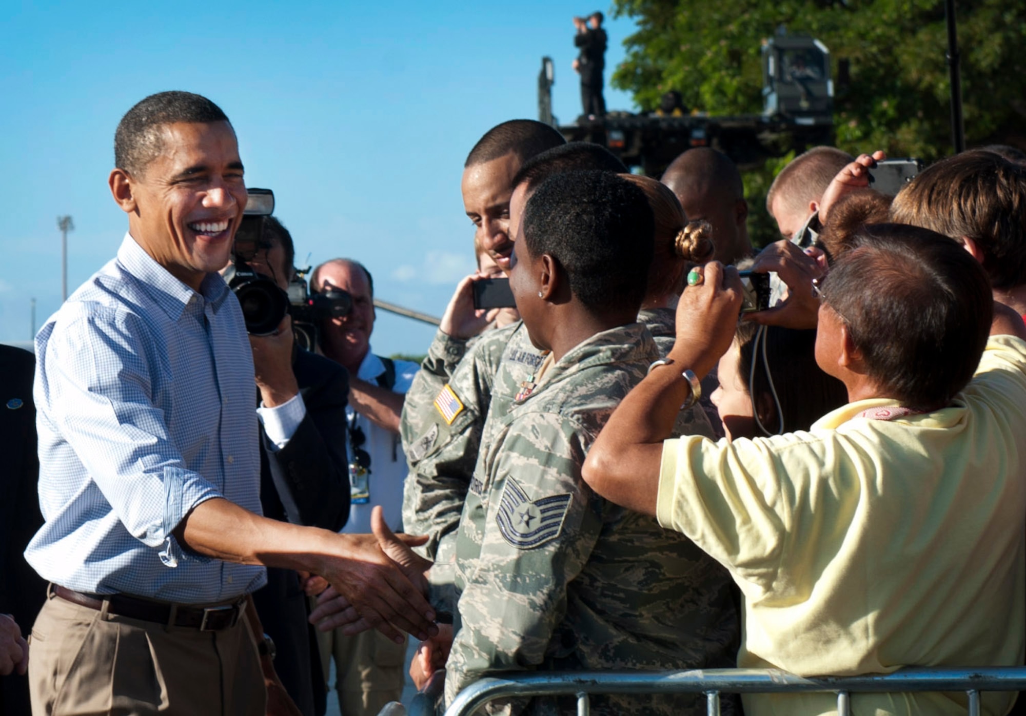 President Barack Obama greets Airmen and their families as he prepares to depart Joint Base Pearl Harbor-Hickam, Hawaii,  following the Asia Pacific Economic Corporation conferences in Honolulu, Nov. 15. The Airmen selected to be apart of the crowd to meet President Obama were selected based on merit and a job well done. (U.S. Air Force photo/Senior Airman Lauren Main)
