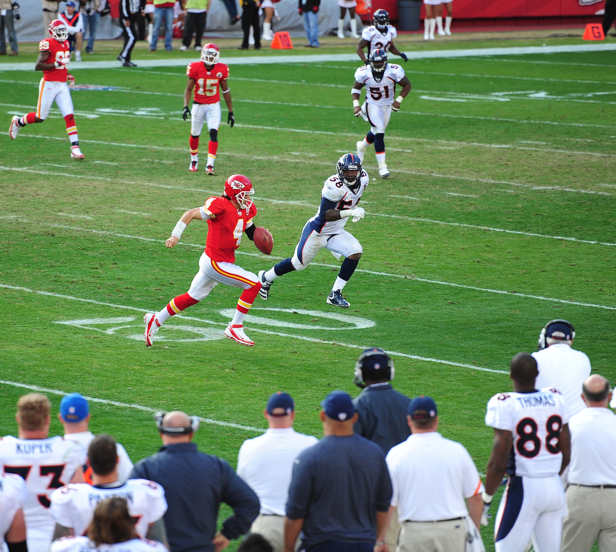 KANSAS CITY, Mo. -- A Kansas City Chief quarterback runs for a first down as a Denver Broncos linebacker follows in pursuit during an American Football Conference West game at Arrowhead Stadium Nov. 13. The Broncos beat the Chiefs 17-10 to clinch a week-long AFC West lead. (U.S. Air Force photo/Senior Airman Nick Wilson)