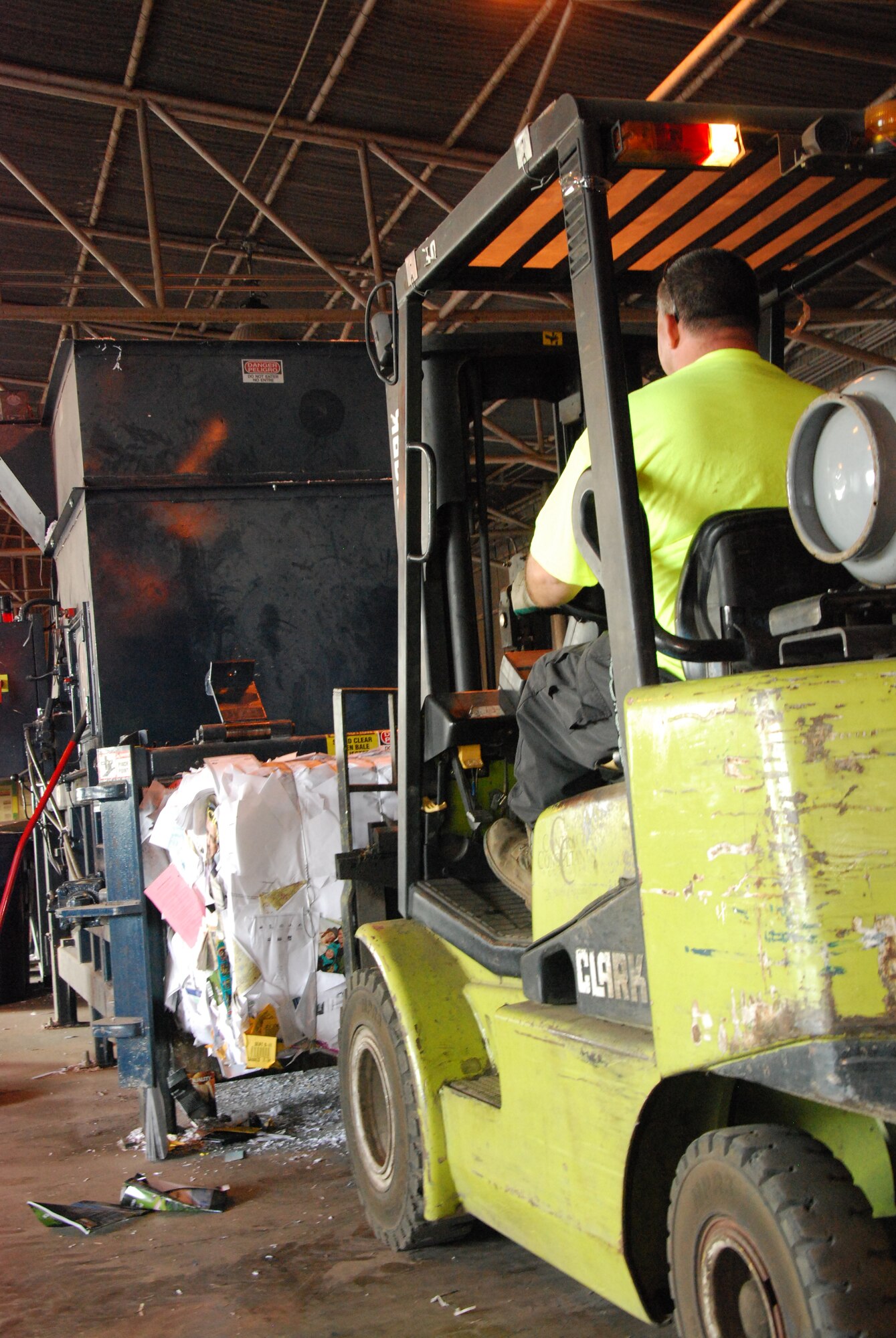 A Sheppard Recycling Center worker uses a forklift to empty a recycling bin into the compactor and to move the compacted bales Nov. 7, 2011. Sheppard Air Force Base, Texas, fights the war against waste year round, not just on America Recycles Day. (U.S. Air Force photo/Capt. Brittany Martin)