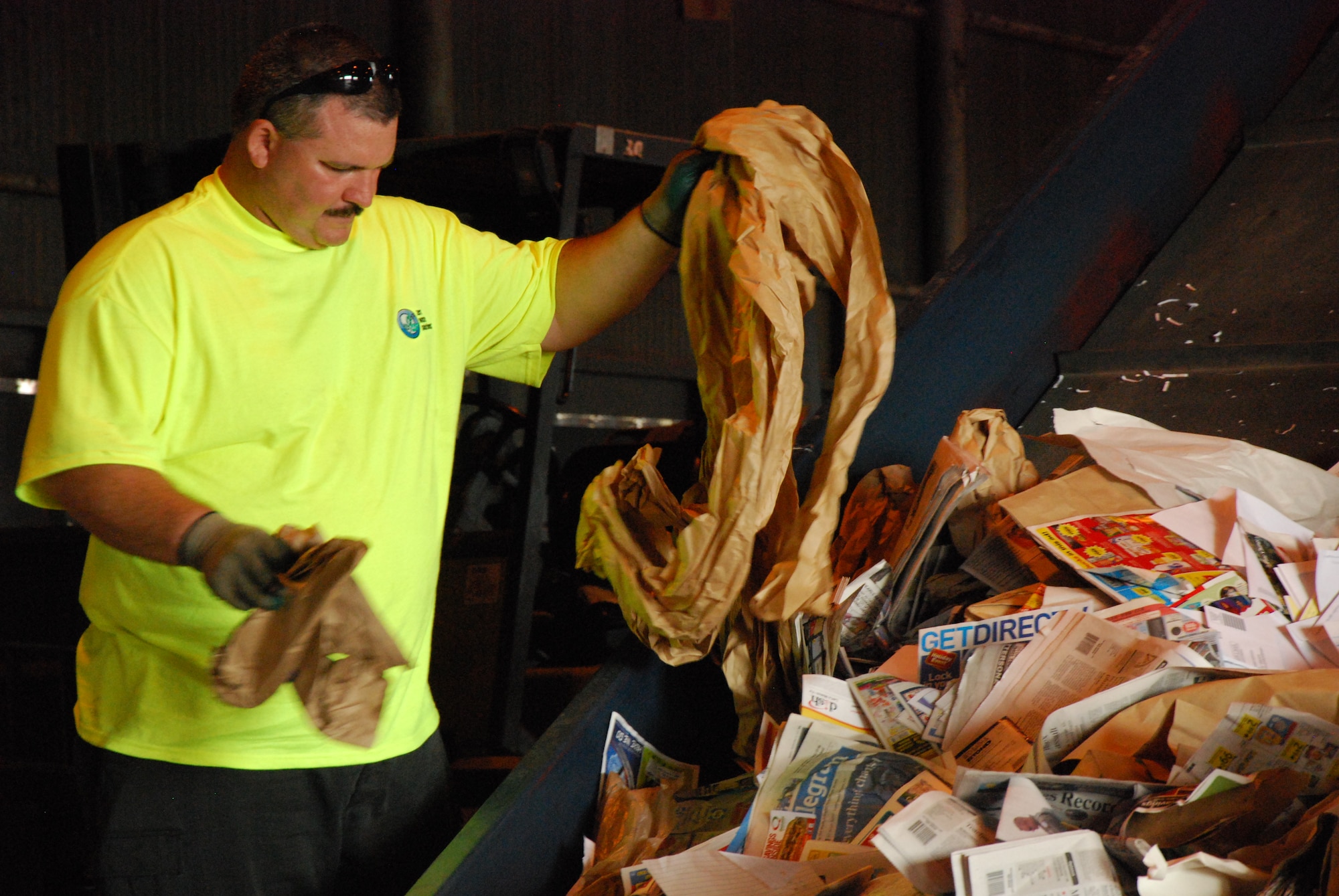 A Sheppard Recycling Center worker sorts through recycled items to separate cardboard from paper Nov. 7, 2011. Sheppard Air Force Base, Texas, fights the war against waste year round, not just on America Recycles Day. (U.S. Air Force photo/Capt. Brittany Martin)