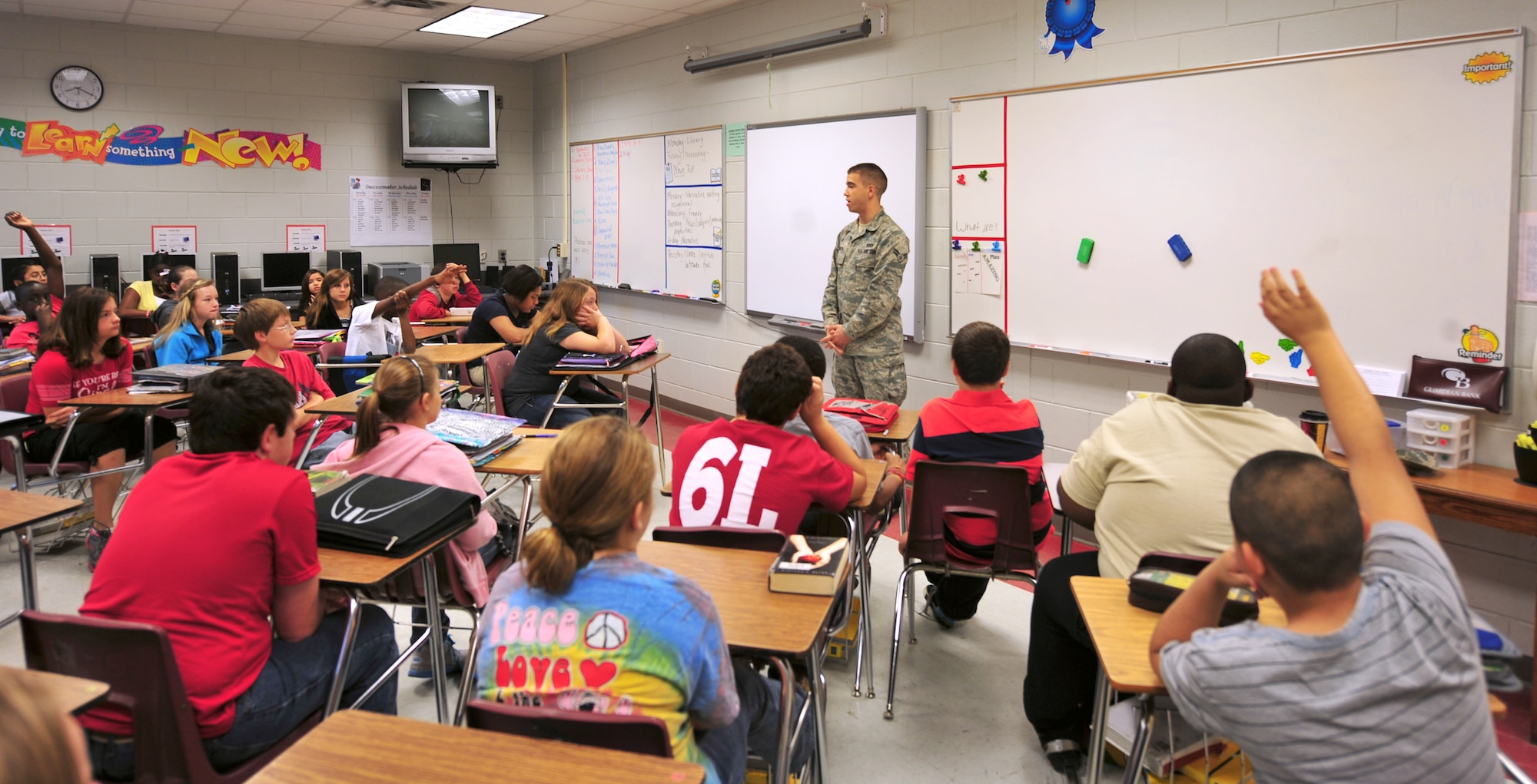 U.S. Air Force Airman 1st Class Nicholas Benroth, 23rd Wing Public Affairs journalist, speaks and answers questions from Lowndes Middle School students Nov. 10, 2011. Twenty-six Airmen from Team Moody volunteered to speak to the students about their career in the Air Force. (U.S. Air Force photo by Staff Sgt. Stephanie Mancha/Released)
