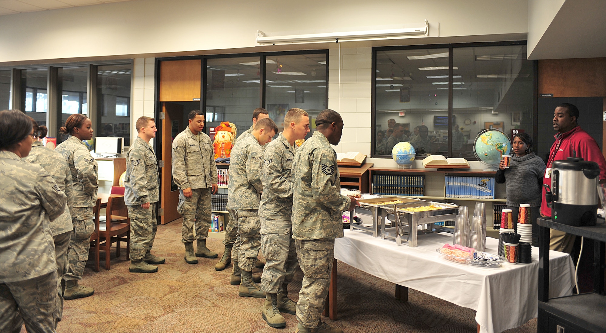 Airmen from Moody Air Force Base, Ga., line up to eat breakfast at Lowndes Middle School Nov. 10, 2011. Airmen were invited to speak to the students during their Veterans Day program. Airmen also volunteered to read to students at Sallas Mahone Elementary School. (U.S. Air Force photo by Staff Sgt. Stephanie Mancha/Released)
