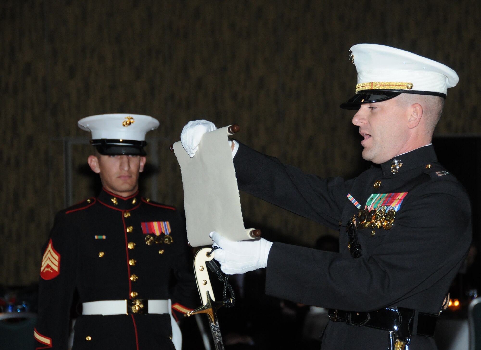 Sgt. Ricardo Asa, Keesler Marine Corps Detachment, stands at attention while Capt. Jason Taylor, MARDET Executive Officer,  reads a birthday message from Gen. John A. Lejeune during the Marine Corps Ball Nov. 10, 2011, at the Mississippi Coast Coliseum Convention Center in Biloxi, Miss.  Gen. Lejeune was the 13th Commandant of the Marine Corps and his birthday message was read at all Balls across the Marine Corps.  (U.S. Air Force photo by Kemberly Groue)
