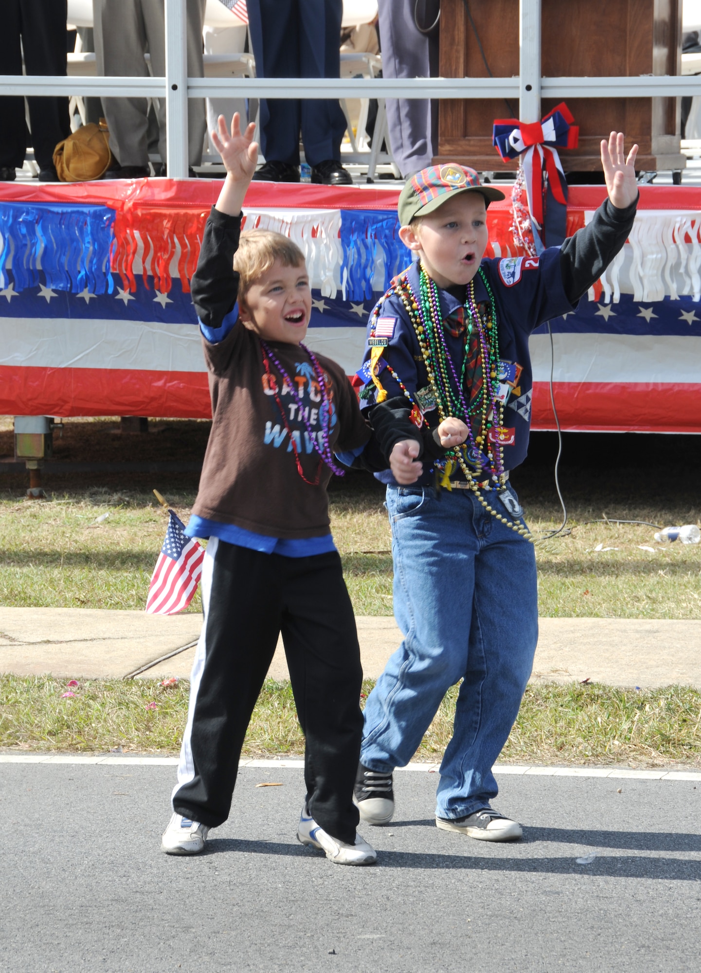 David Solomon, 6, and AJ Wright, 9, call out for beads being thrown from floats as they pass by during the 11th Annual Gulf Coast Veterans Day Parade in D’Iberville, Miss., Nov. 12, 2011.  David is the son of Lt. Col. Scott and Devalynn Solomon, 81st Training Group.   AJ is the son of Lt. Col. Jonathan and Lisa Wright, 81st Mission Support Group.  (U.S. Air Force photo by Kemberly Groue)