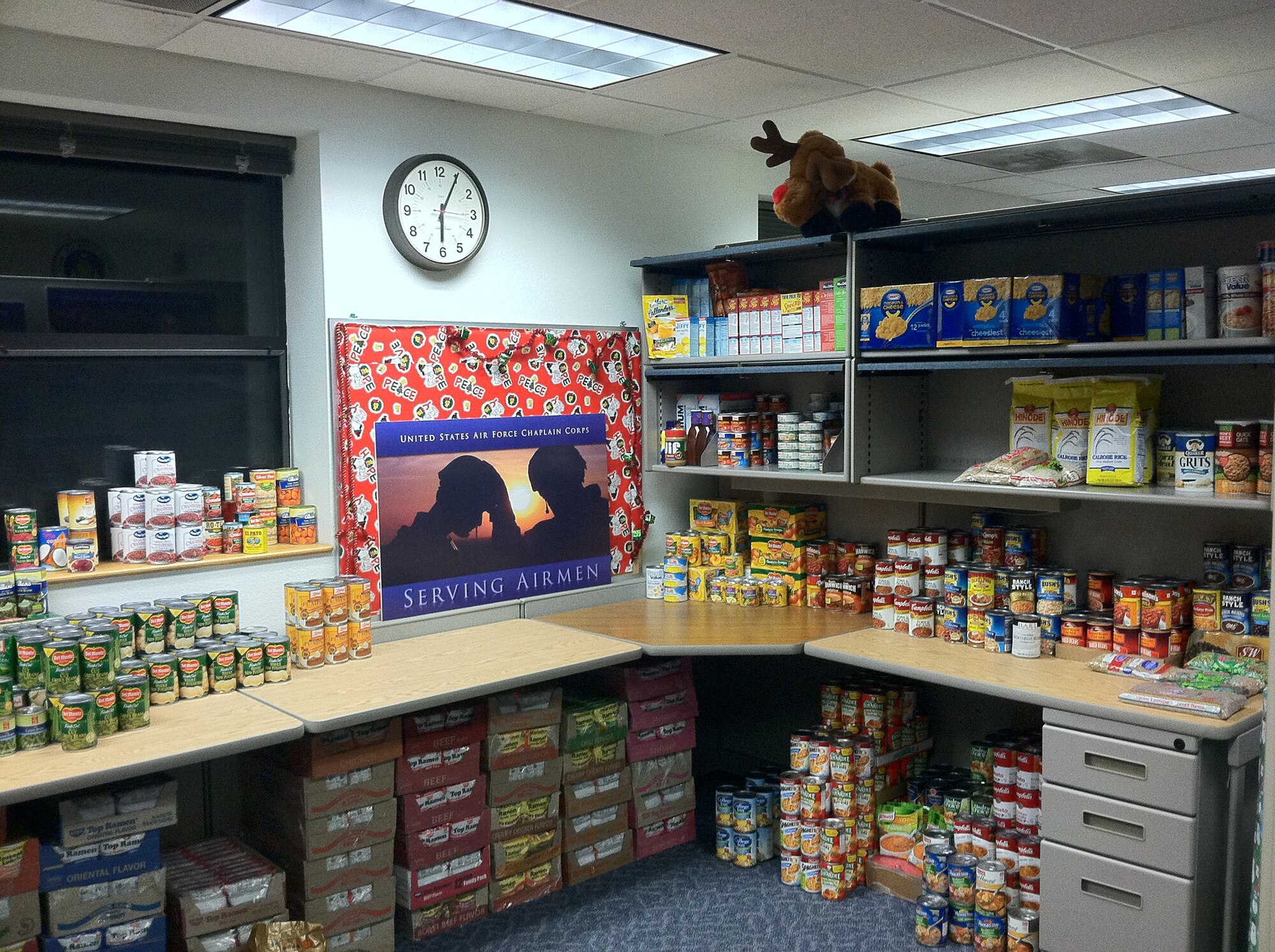 TRAVIS AIR FORCE BASE, Calif. -- The 349th Air Mobility Wing Holiday Food Drive is underway.Staff Sgt. Kenyetta King, chaplains assistant, set up a 349th 'shopping mart' with the many food items donated. The 349th AMW chaplain corps sponsors the annual drive to feed those in need in Solano County and within our Air Force family. There are decorated barrels throughout the wing in various locations for dropping off non-perishable food items, or stop by the Chaplains Office, and they can take your donation. The drive ends Dec. 15, in time to distribute the food for the holidays. (U.S. Air Force photo/Master Sgt. Rita Houchin).
