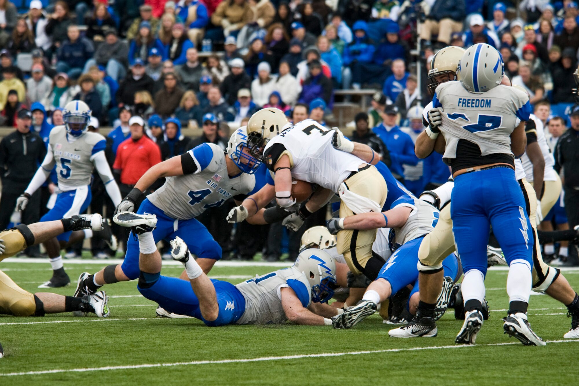 The Air Force Falcons gang tackle an Army Knights running back during the second half of the football game at the Air Force Academy, Colo., Nov. 5, 2011. At halftime the Army Knights were up by two touchdowns 14-0, the second half was dominated by the Falcons which went on a 24-0 run with the final score of 24-14 winning. (U.S. Air Force photo by Airman Alystria Maurer/Released)